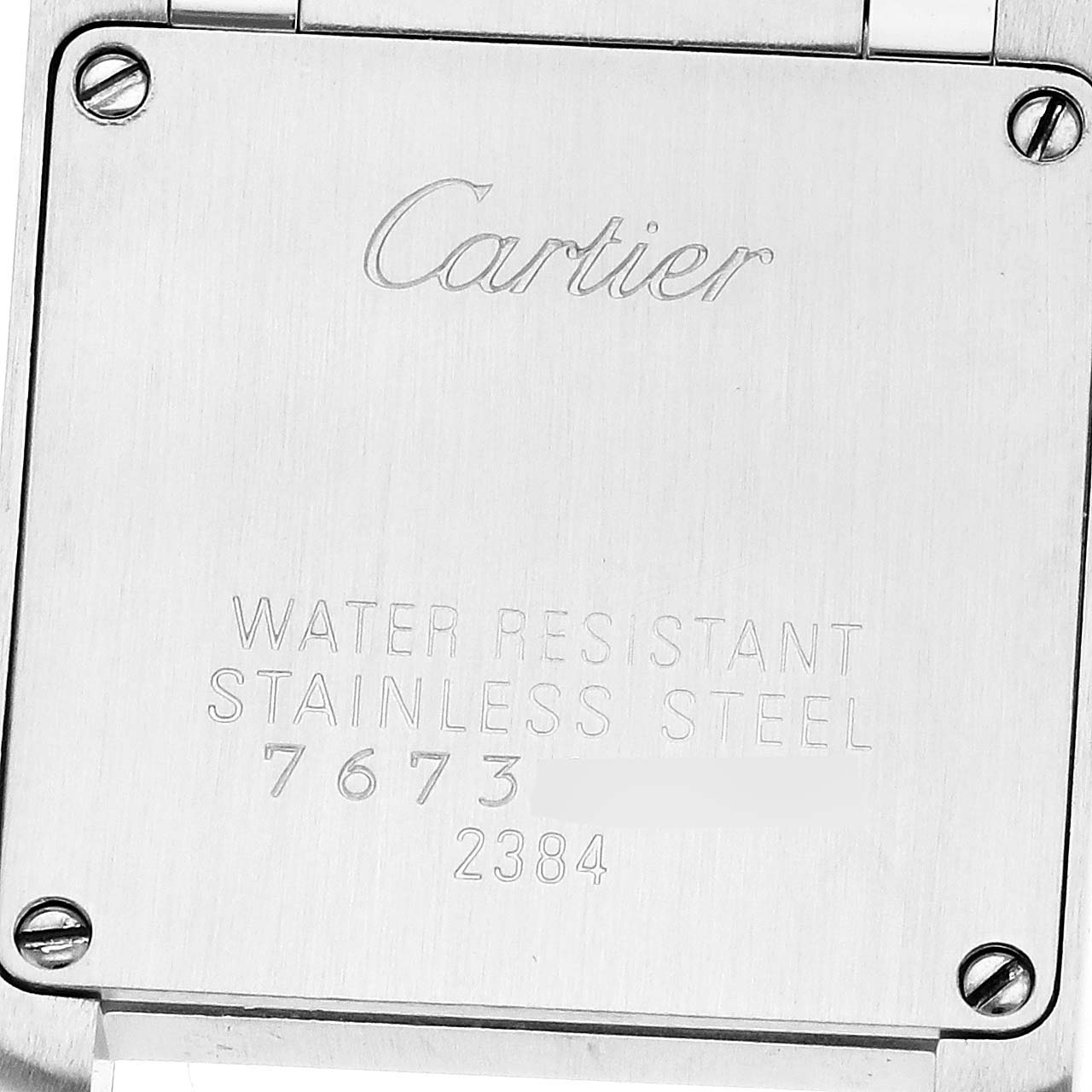 The image shows the back case of a Cartier Tank Francaise W51007Q4 Women
s Steel and Gold (two tone) Silver Dial watch, displaying engravings and four screws.