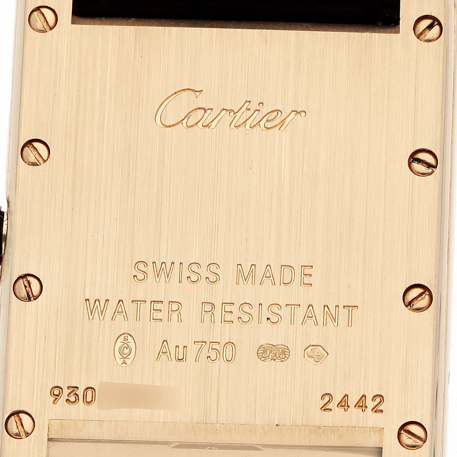 The image shows the back case of a Cartier Tank Louis W1529856 Women
s Yellow Gold Silver Dial watch, displaying engravings and screws.