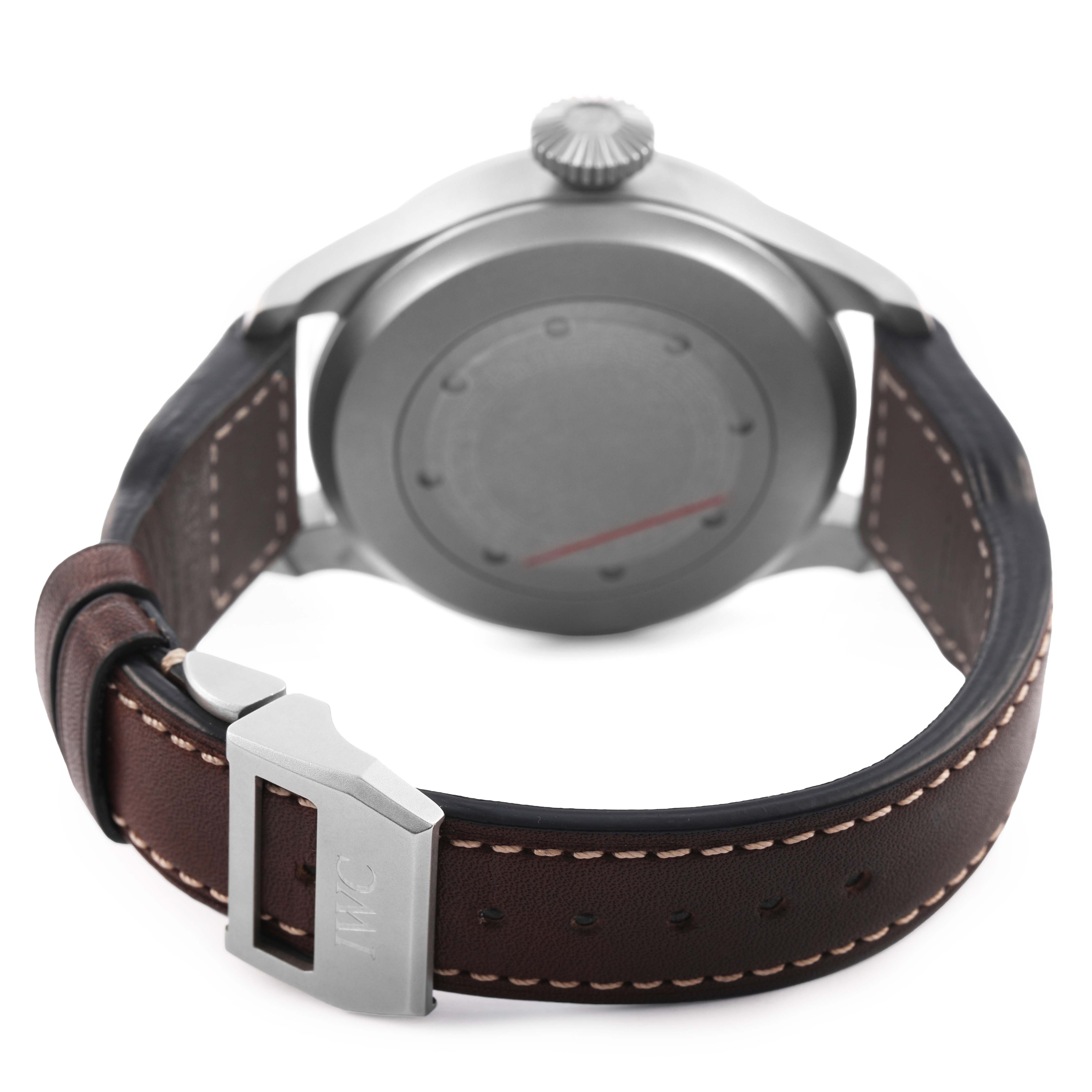 The image shows the back of the IWC Pilot IW510301 Men's Titanium Black Dial watch, highlighting its case, crown, and brown leather strap with a buckle.
