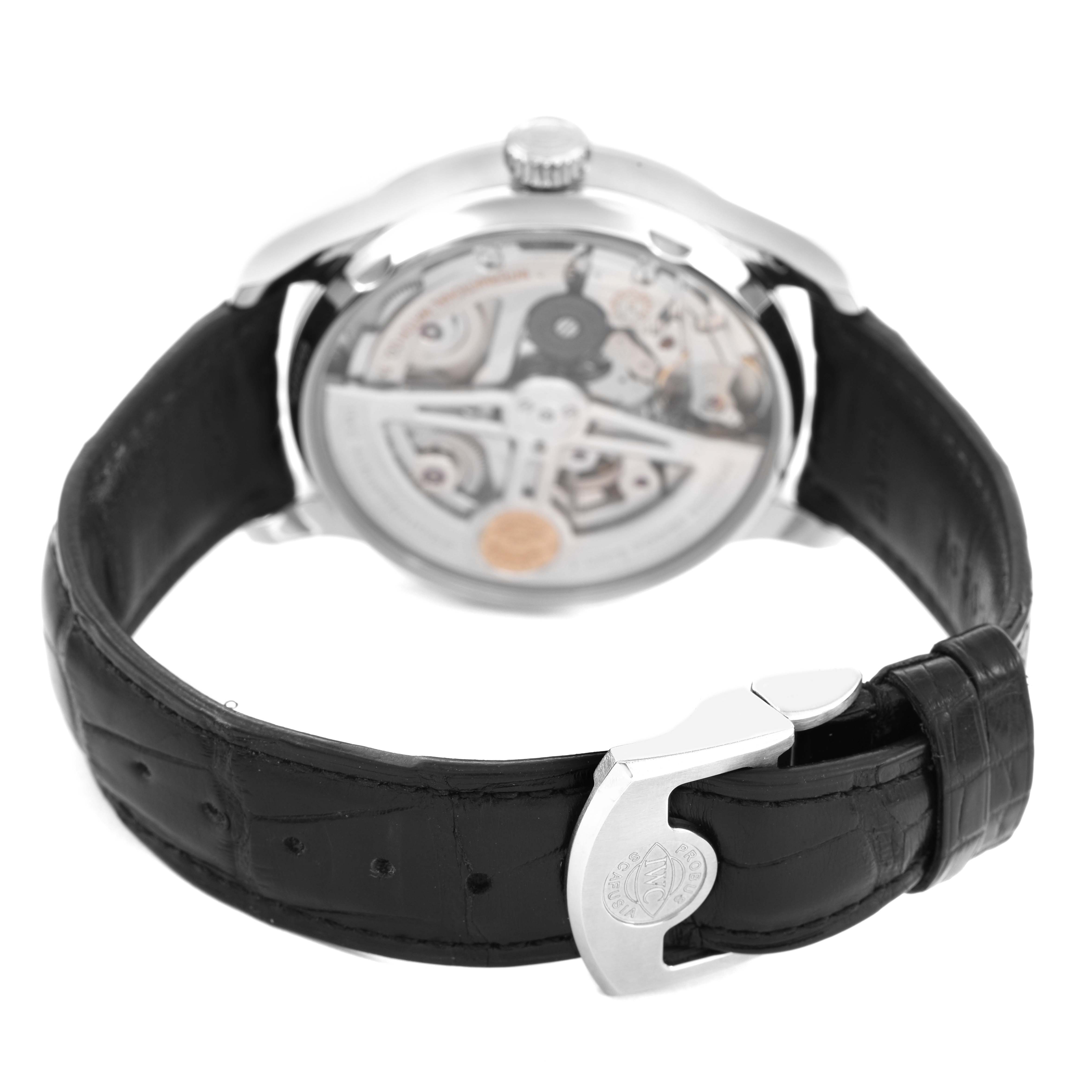 The watch is an IWC Portuguese IW500710 Men's Stainless Steel Blue Dial model shown from the back, highlighting the movement and clasp on its leather strap.