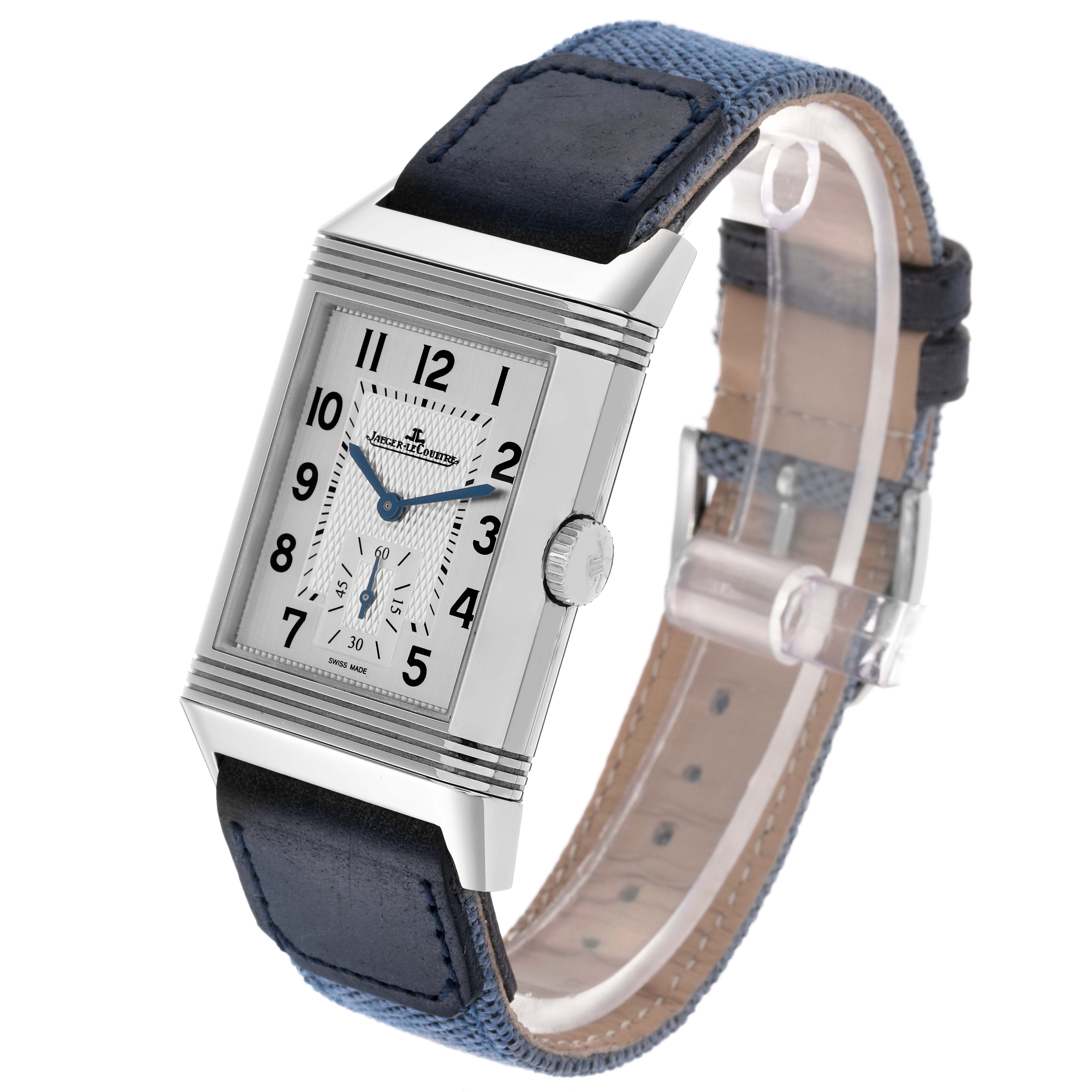 The Jaeger-LeCoultre Reverso watch is shown at a slight angle, revealing its rectangular face, crown, and blue strap.