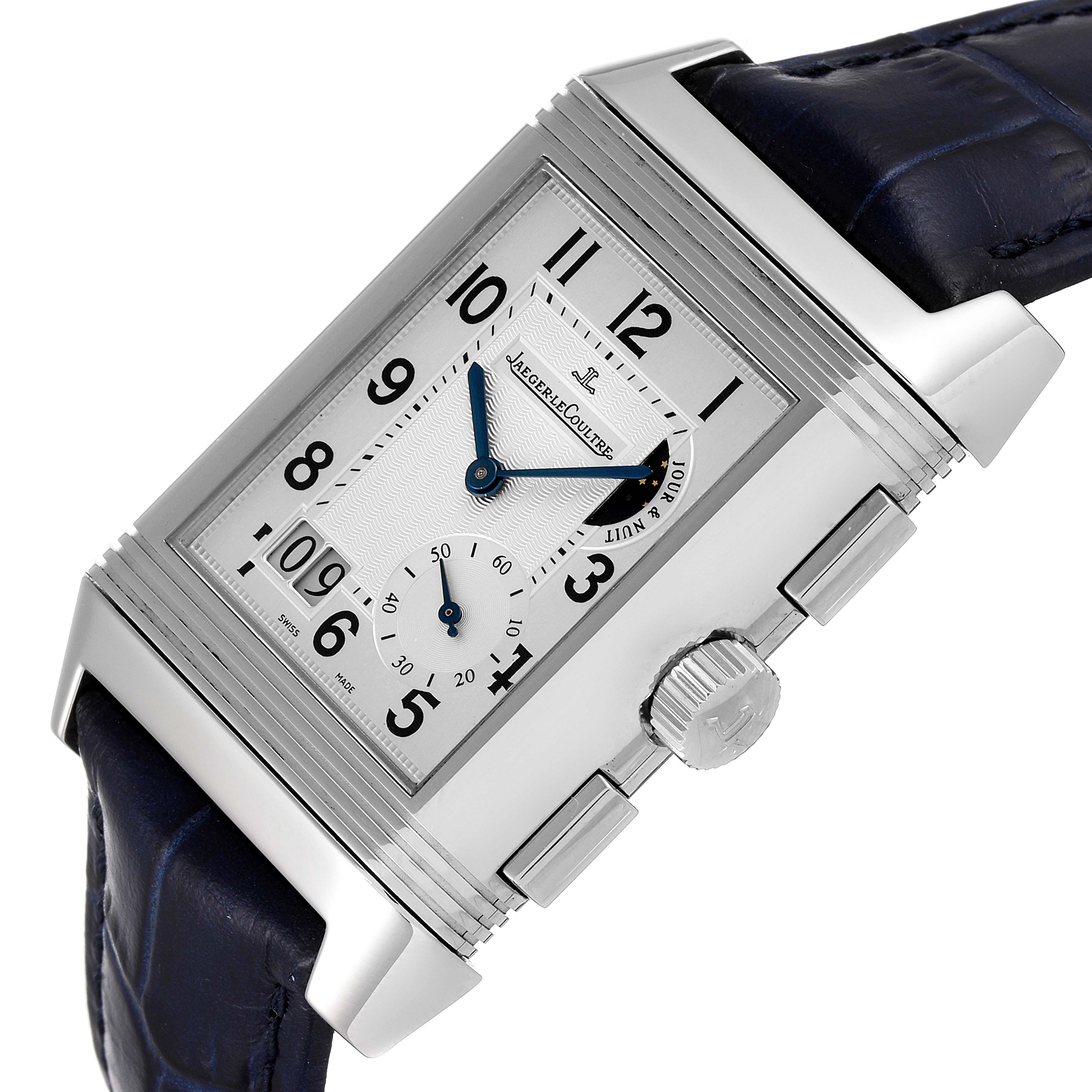 The image shows a Jaeger LeCoultre Reverso Q3028420 Men's Stainless Steel Silver Dial Q3028420 Men's Stainless Steel Silver Dial watch at an angled view, highlighting the dial, side crown, and blue leather strap.