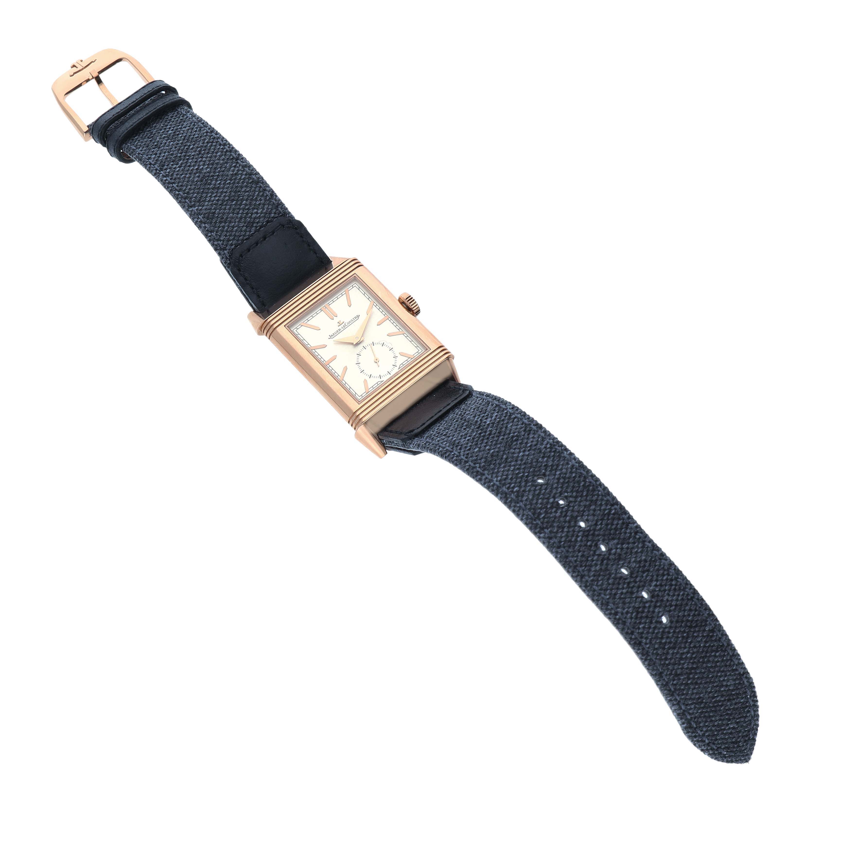 The Jaeger-LeCoultre Reverso watch is shown at a slight angle, displaying the face, crown, and entire strap.