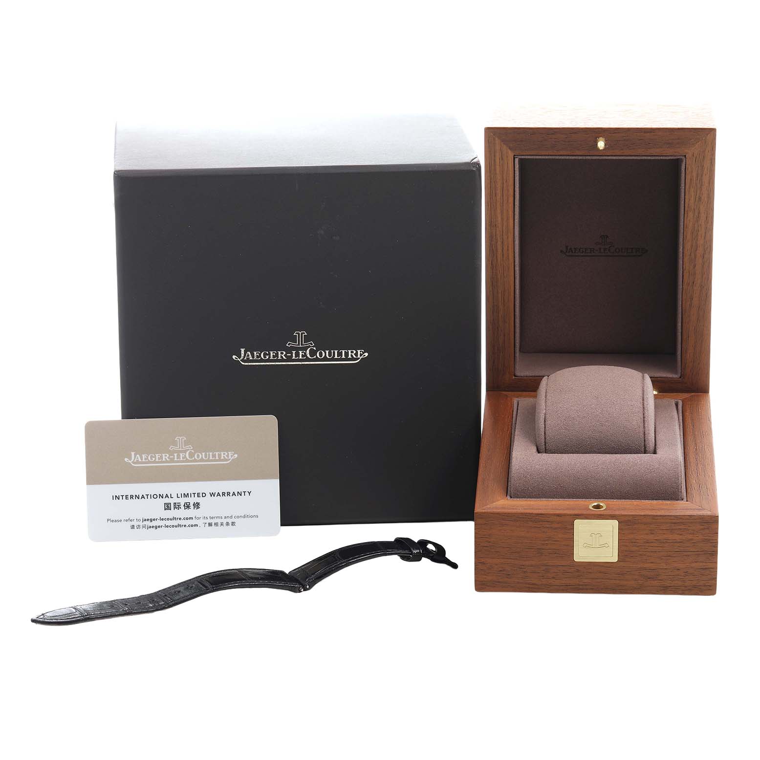 The image shows the Jaeger-LeCoultre Reverso packaging, an empty watch box, an international warranty card, and a watch strap.