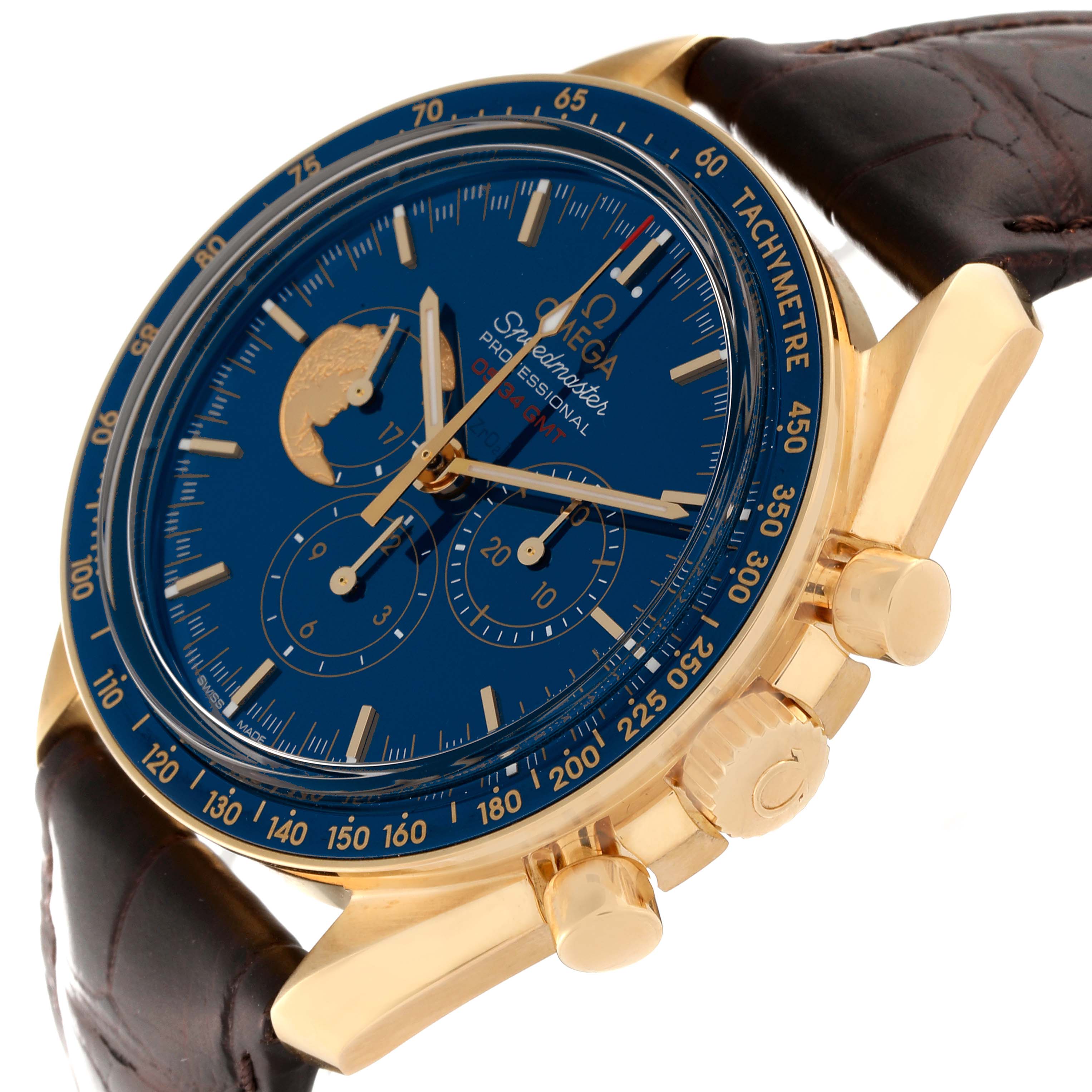 The image shows an angled view of the Omega Speedmaster 311.63.42.30.03.001 Men's Yellow Gold Blue Dial 311.63.42.30.03.001 Men's Yellow Gold Blue Dial watch, highlighting its blue dial, gold case, tachymeter bezel, and chronograph pushers.