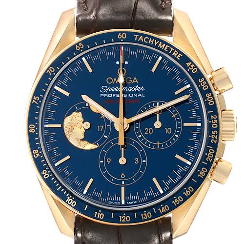 This image shows the Omega Speedmaster watch face, featuring a gold case, tachymeter bezel, subdials, and leather strap at a front angle.