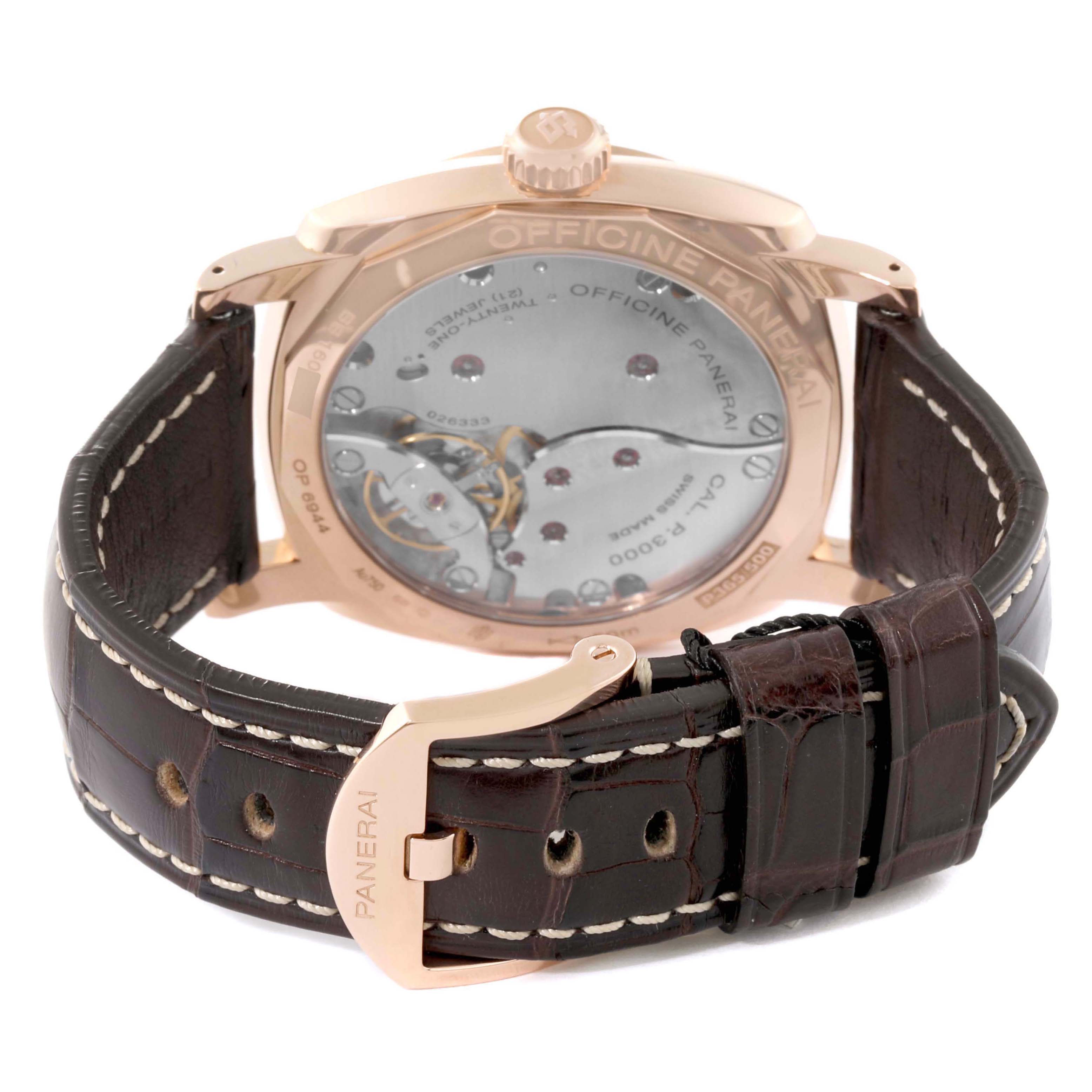 The Panerai Radiomir PAM00515 Men's Rose Gold Black Dial watch is shown from the back, displaying its case back and movement, along with a detailed view of the leather strap and clasp.