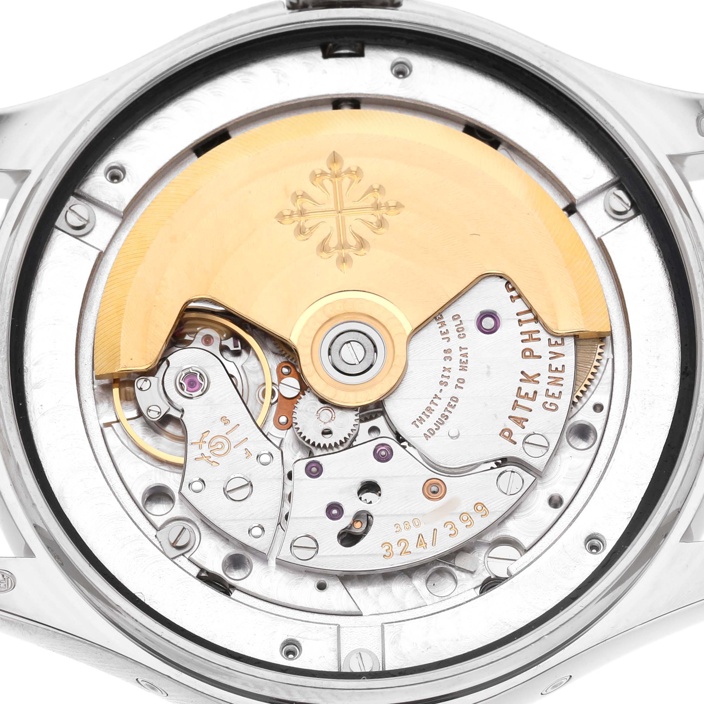 The image shows the movement from the back of the Patek Philippe Complications 5146G-001 Men's White Gold Grey Dial watch, highlighting the rotor and intricate mechanics.