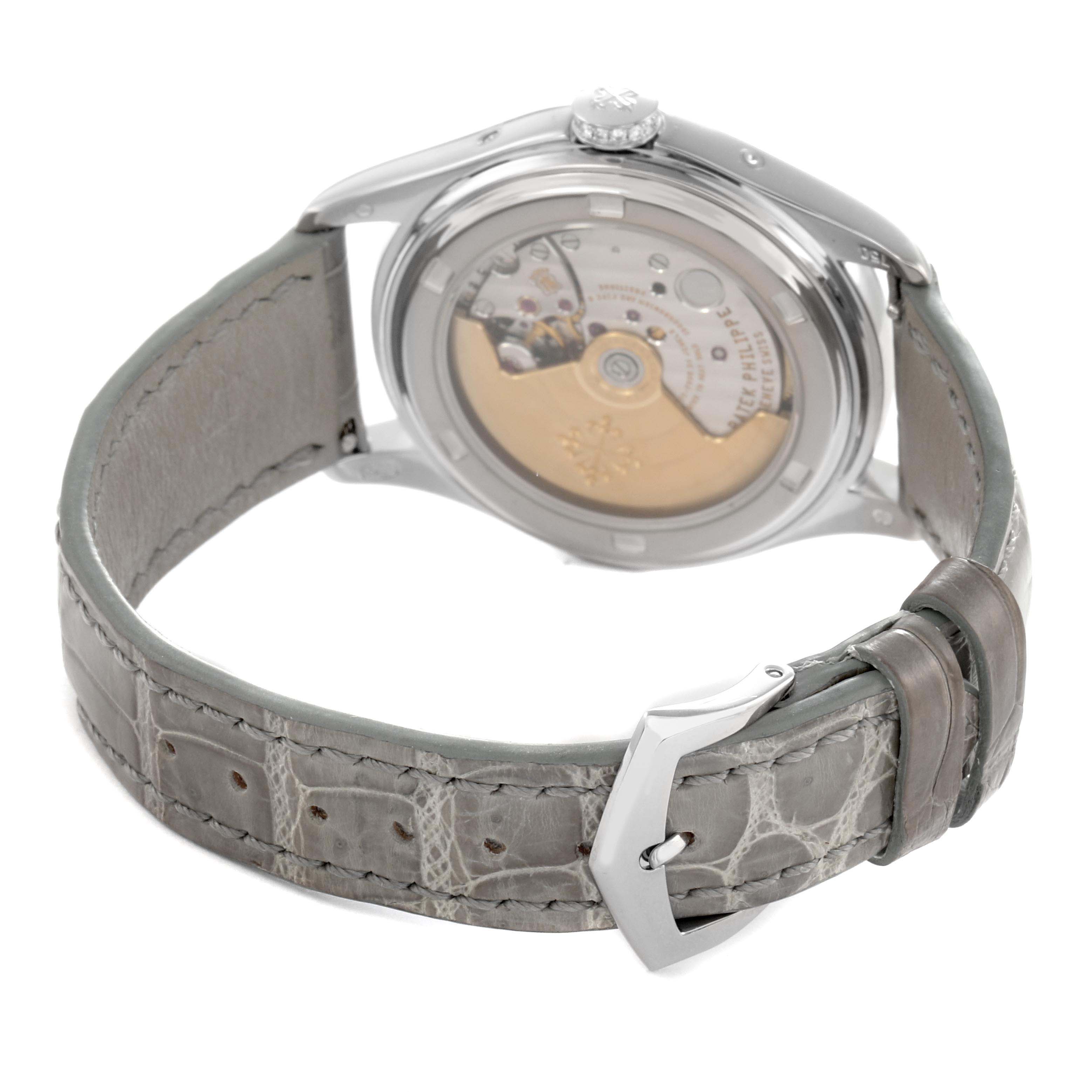 The Patek Philippe Complications 4936 Men
s White Gold Mother of Pearl Dial watch is shown from the back, highlighting the movement and gray leather strap with a buckle.