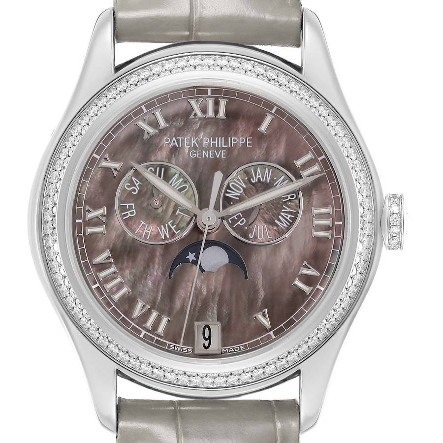 The Patek Philippe Complications model 4936 is shown from a front angle, displaying the dial, hands, calendar sub-dials, moon phase indicator, and bezel with diamonds.