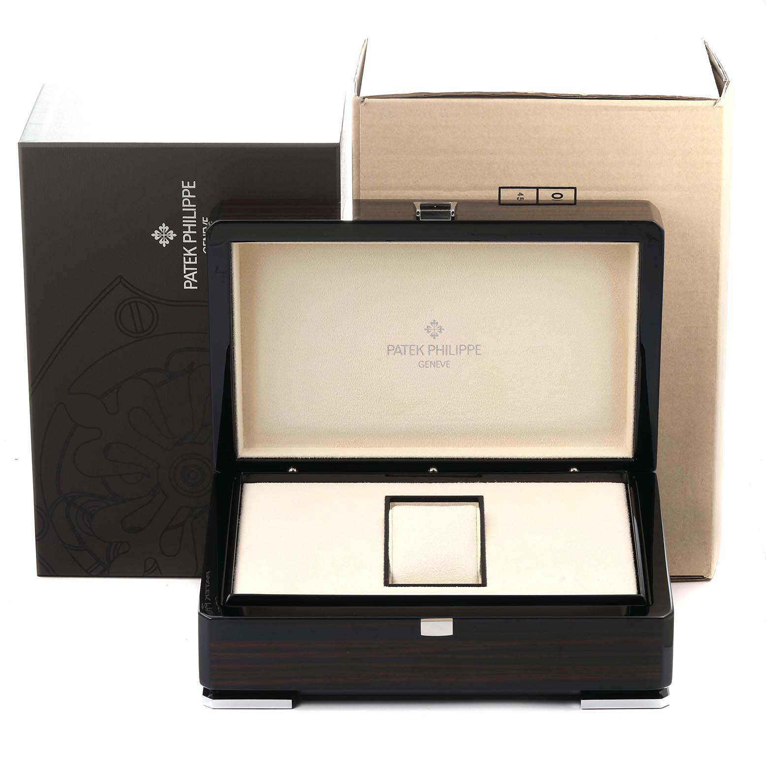 The image shows an open Patek Philippe Complications 4936 Men
s White Gold Mother of Pearl Dial watch box, displaying its interior with the brand name inside the lid.