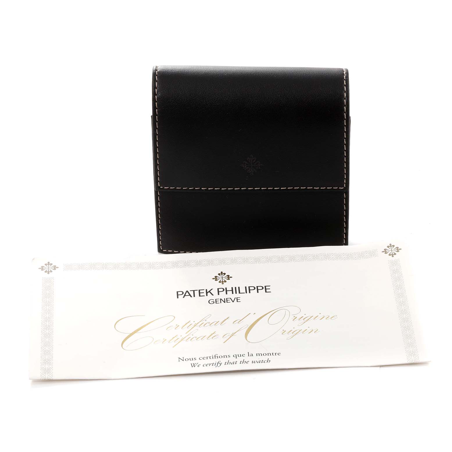 The image shows the certificate of origin and a leather pouch for the Calatrava model by Patek Philippe.