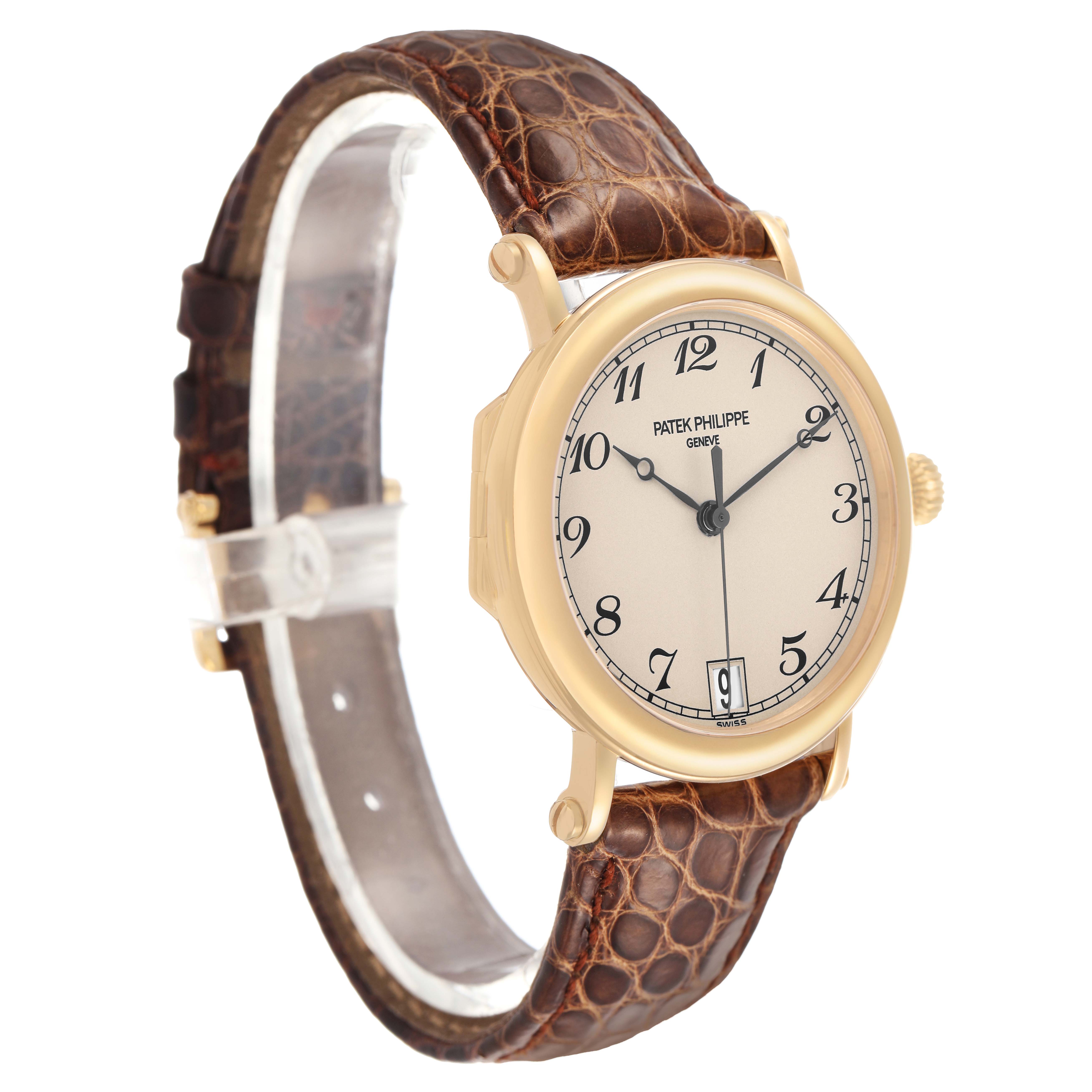 The Patek Philippe Calatrava 5053J Men's Yellow Gold White Dial watch is shown at a slight angle, highlighting the dial, case, and brown leather strap.