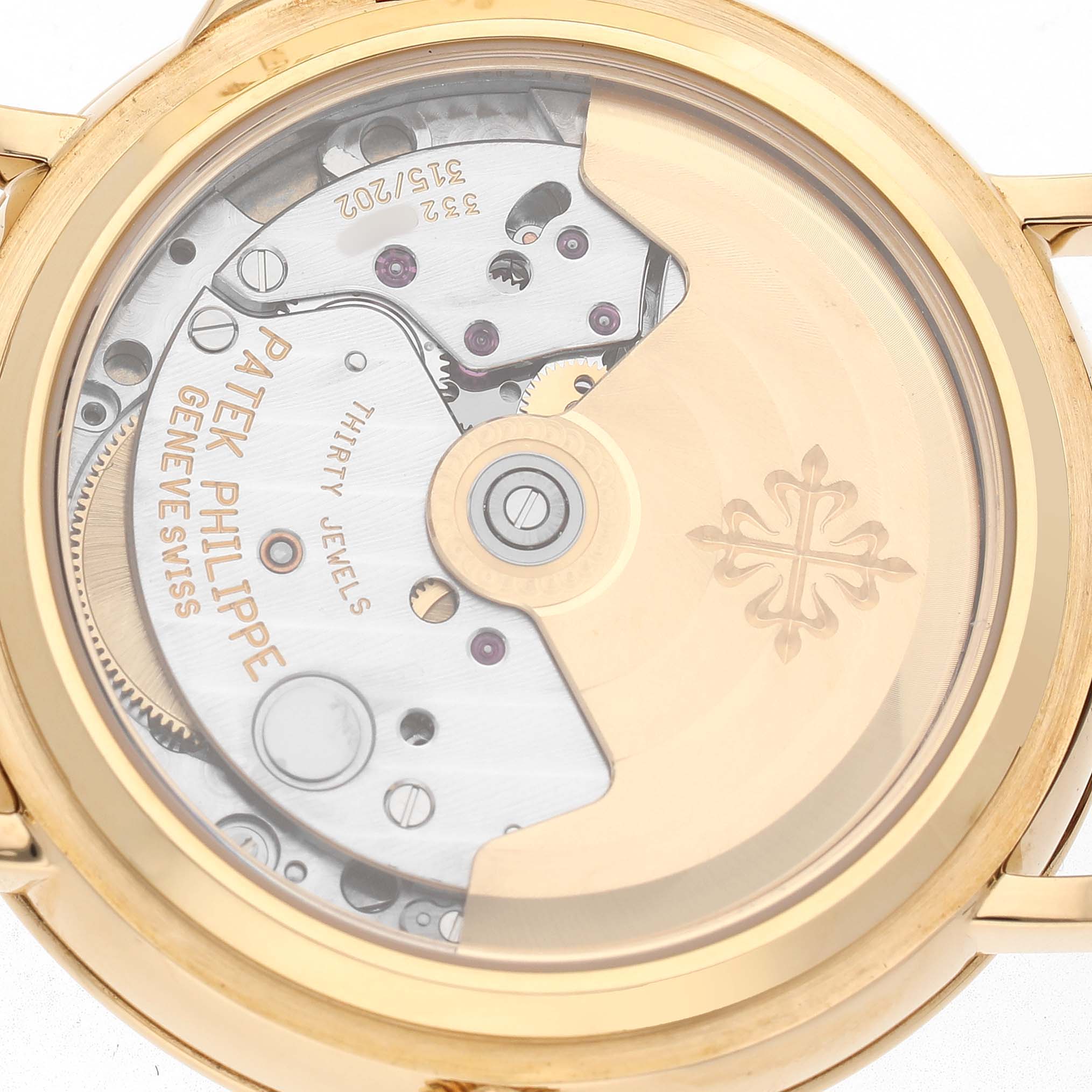 The image shows a rear view of the Patek Philippe Calatrava 5053J Men's Yellow Gold White Dial, highlighting its mechanical movement and rotor details.
