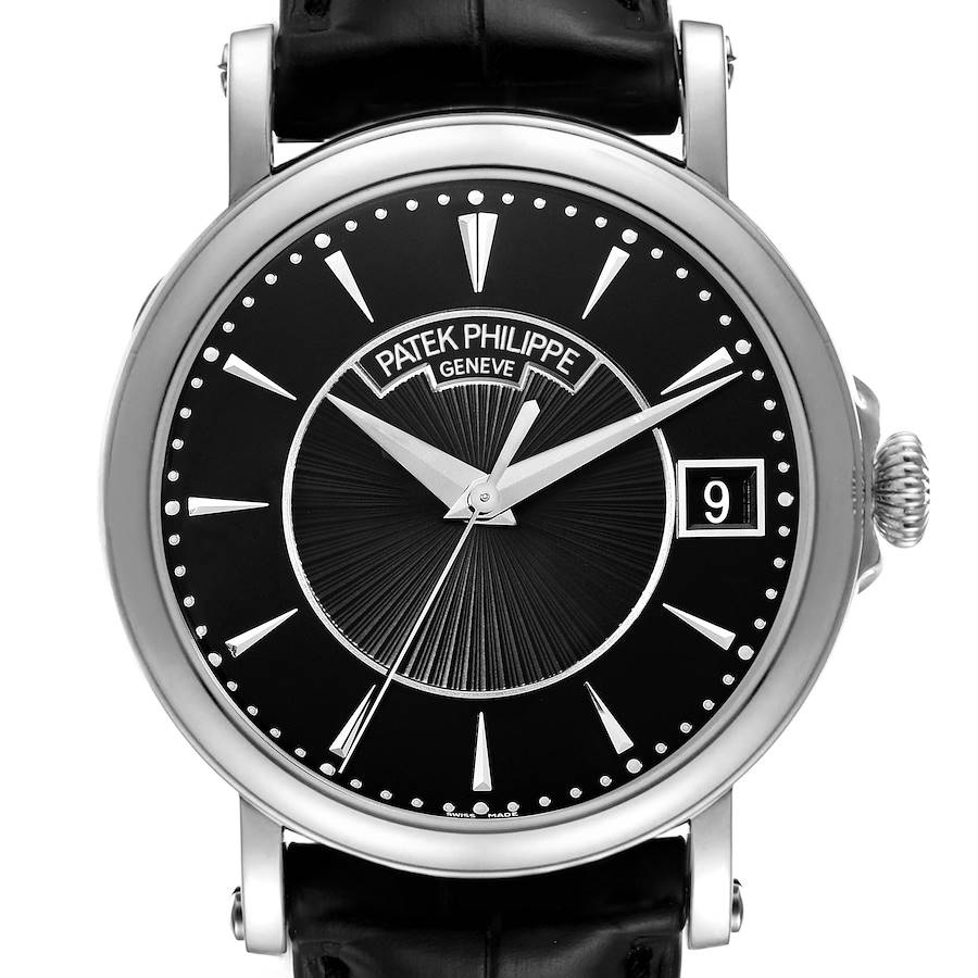 The Patek Philippe Calatrava watch is shown from the front, highlighting the black dial, silver hands, index markers, and crown.