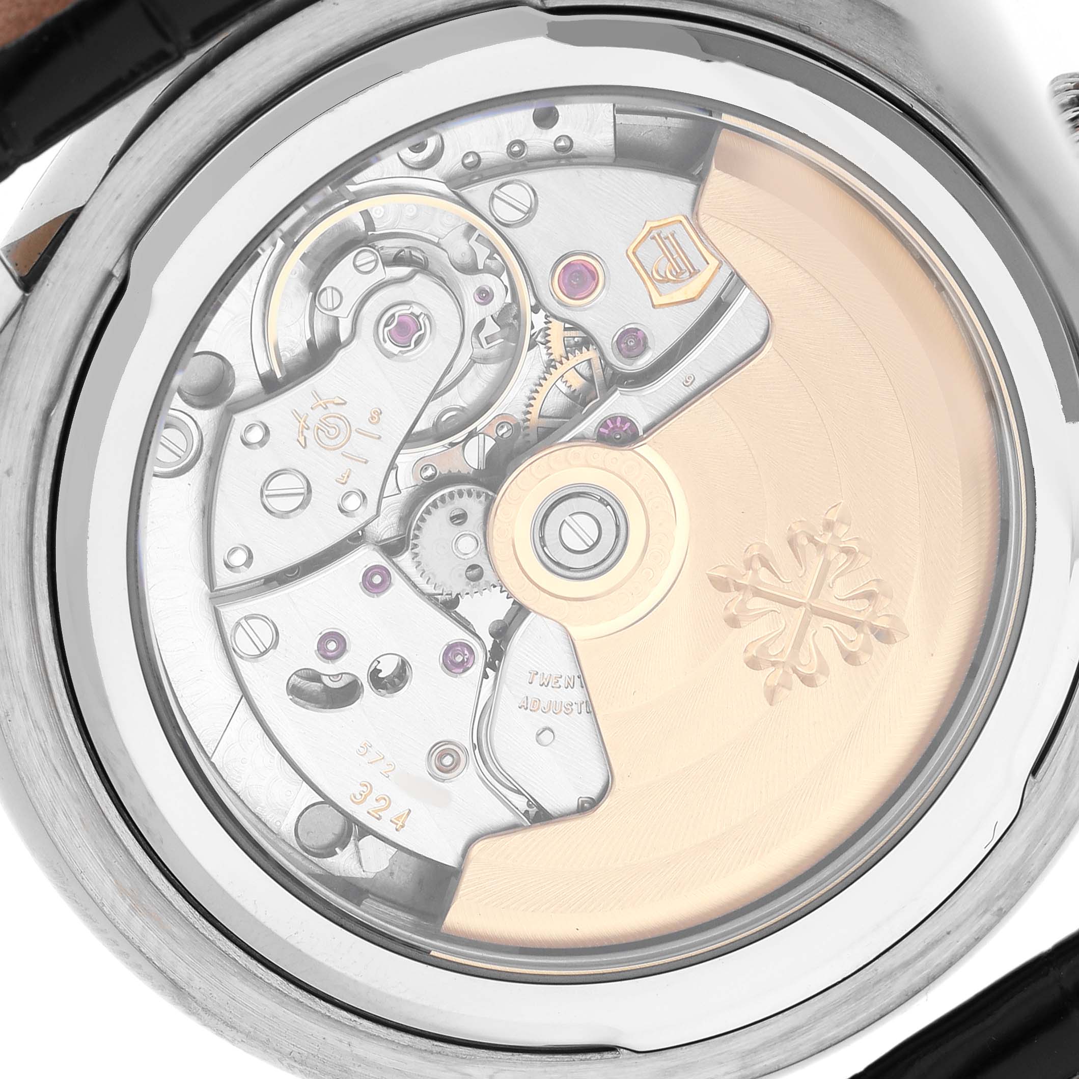 The image shows the back view of a Patek Philippe Calatrava 5153G-001 Men's White Gold Black Dial, revealing its intricate movement and rotor.