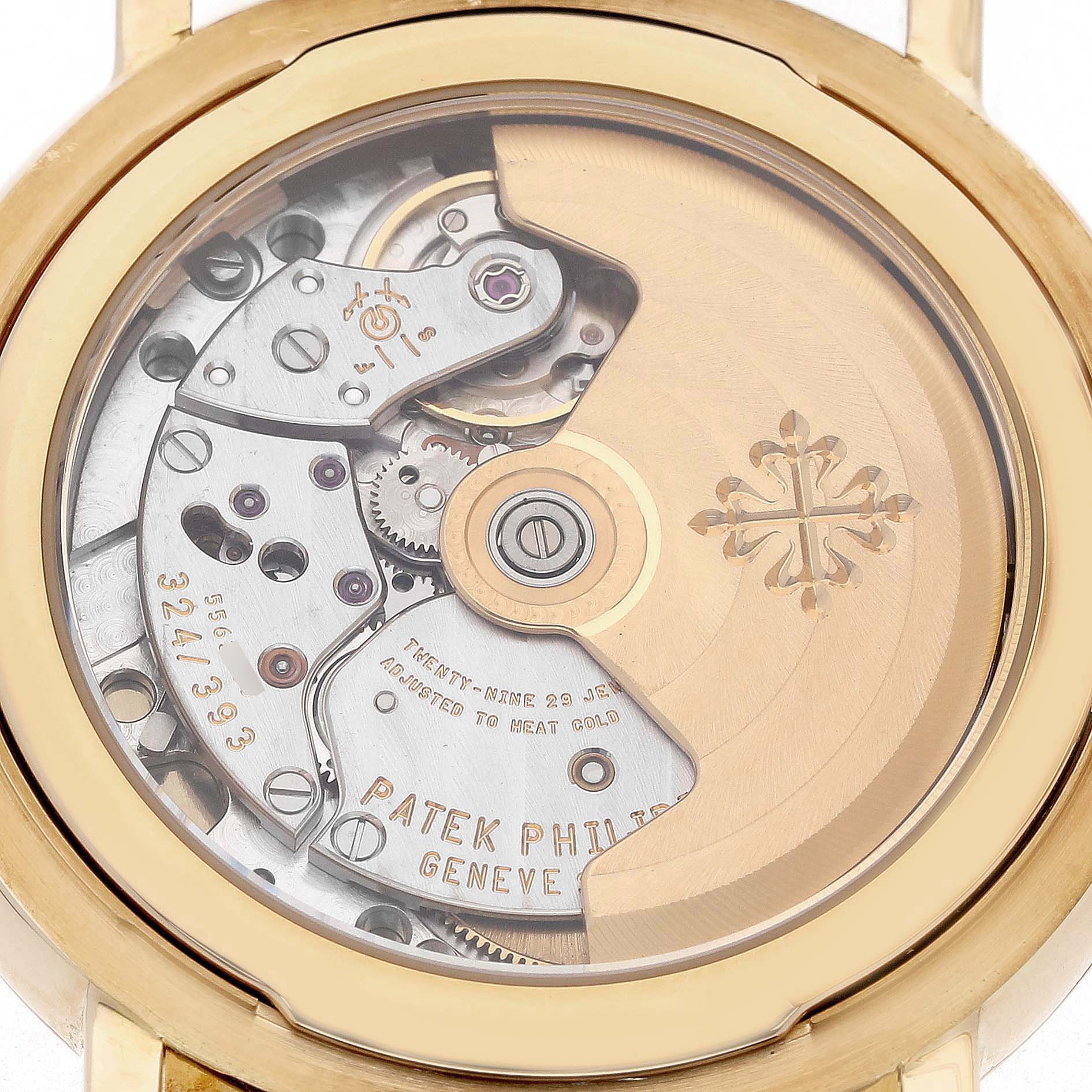 The image shows the back view of a Patek Philippe Calatrava 5153J Men's Yellow Gold Silver Dial, highlighting its mechanical movement and oscillating weight.