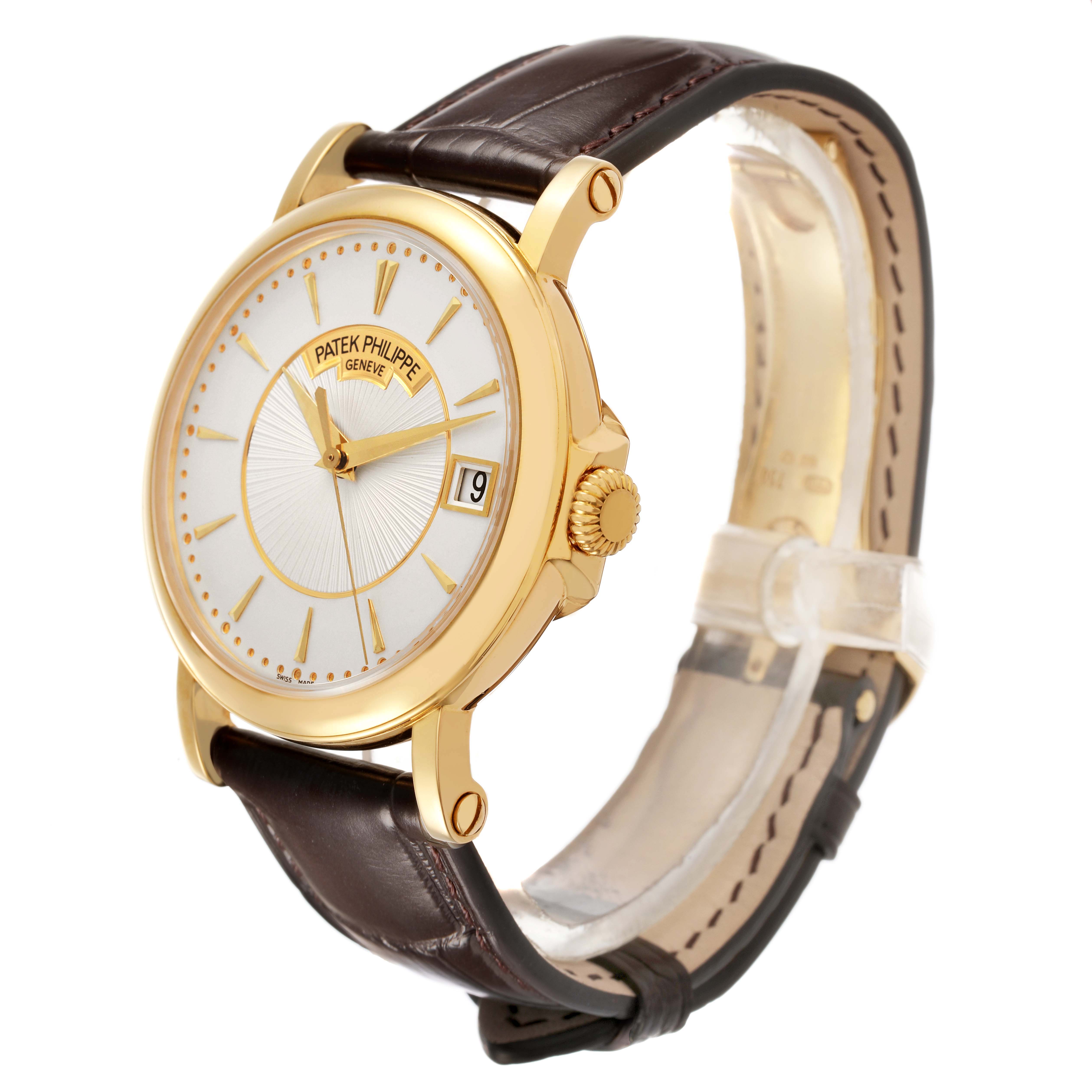 The Patek Philippe Calatrava 5153J Men's Yellow Gold Silver Dial watch is shown at a three-quarter angle, showcasing the dial, case, crown, and leather strap.