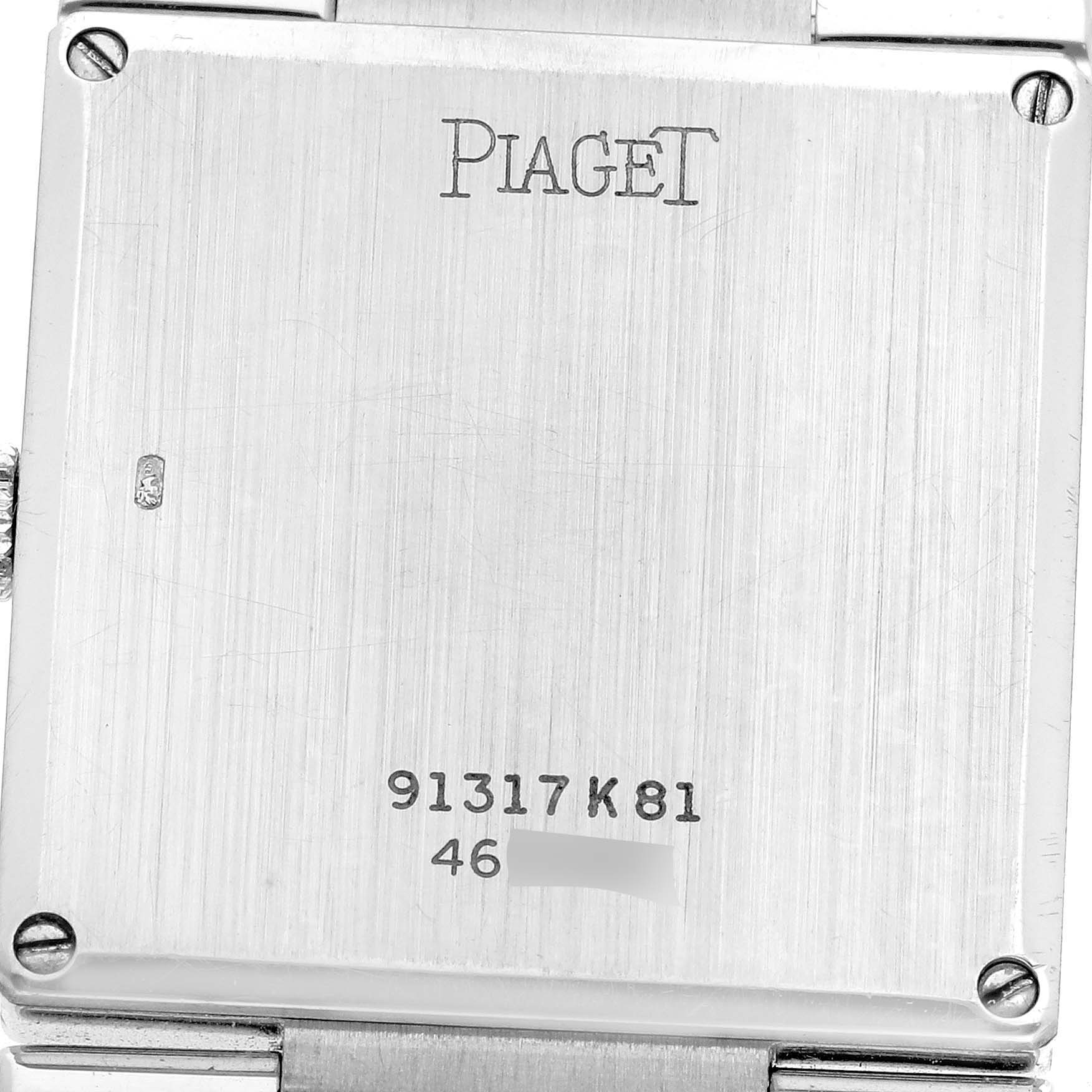 The image shows the back case of the Piaget 91317 Women
s White Gold Silver Dial Dancer White Gold Ultra Thin Vintage Ladies Watch 91317, displaying branding and model engraving.