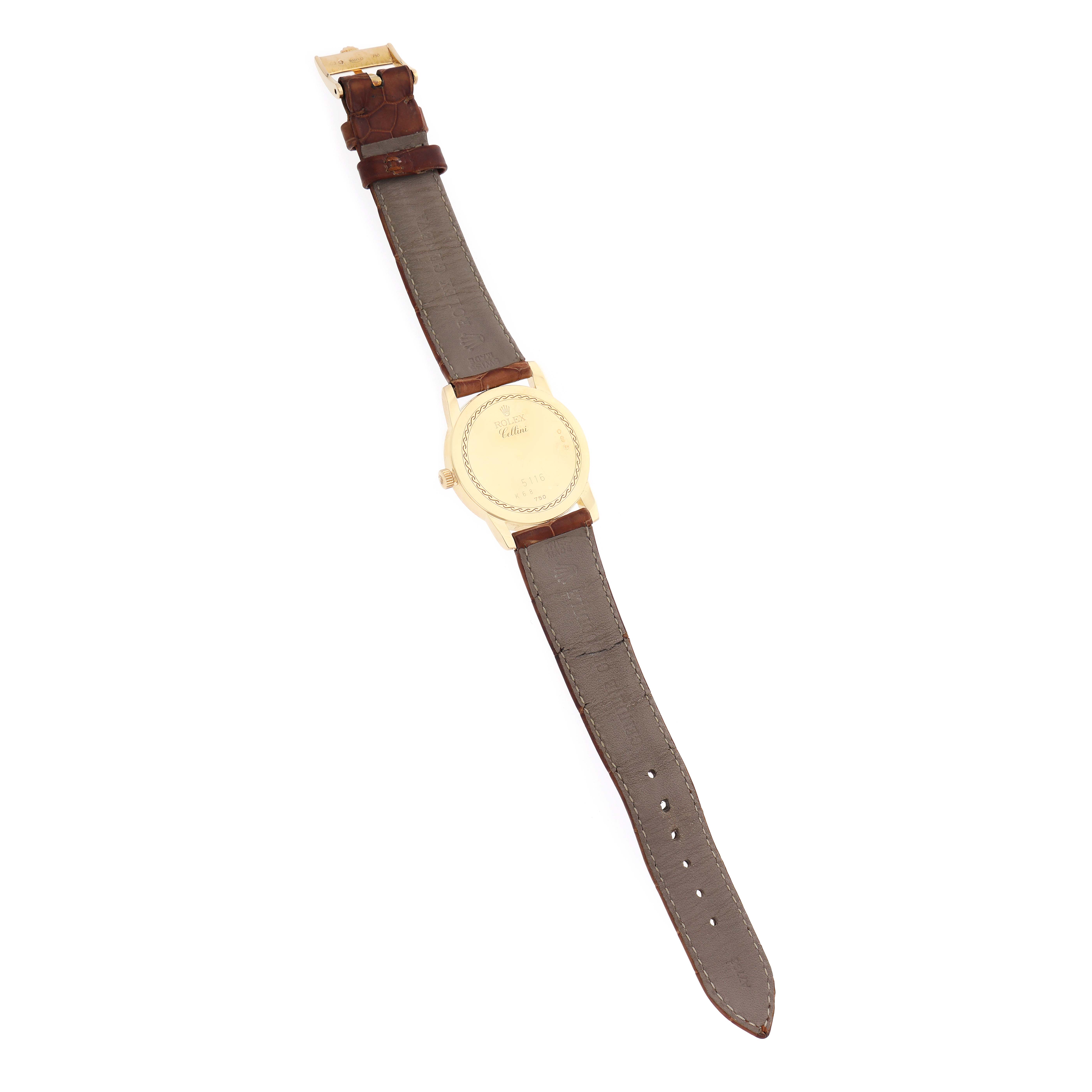 The Rolex Cellini 5116 Men
s Yellow Gold Beige Dial watch is shown from the back, displaying its case, leather strap, and buckle.