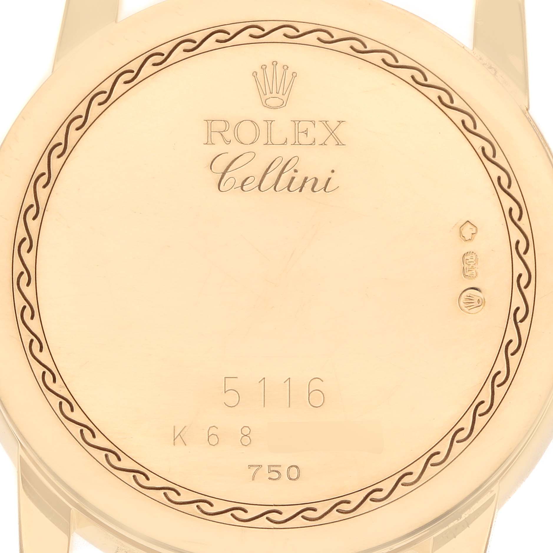 The image shows the back case of a Rolex Cellini 5116 Men
s Yellow Gold Beige Dial watch, highlighting the engraved brand name, model number, and decorative border.