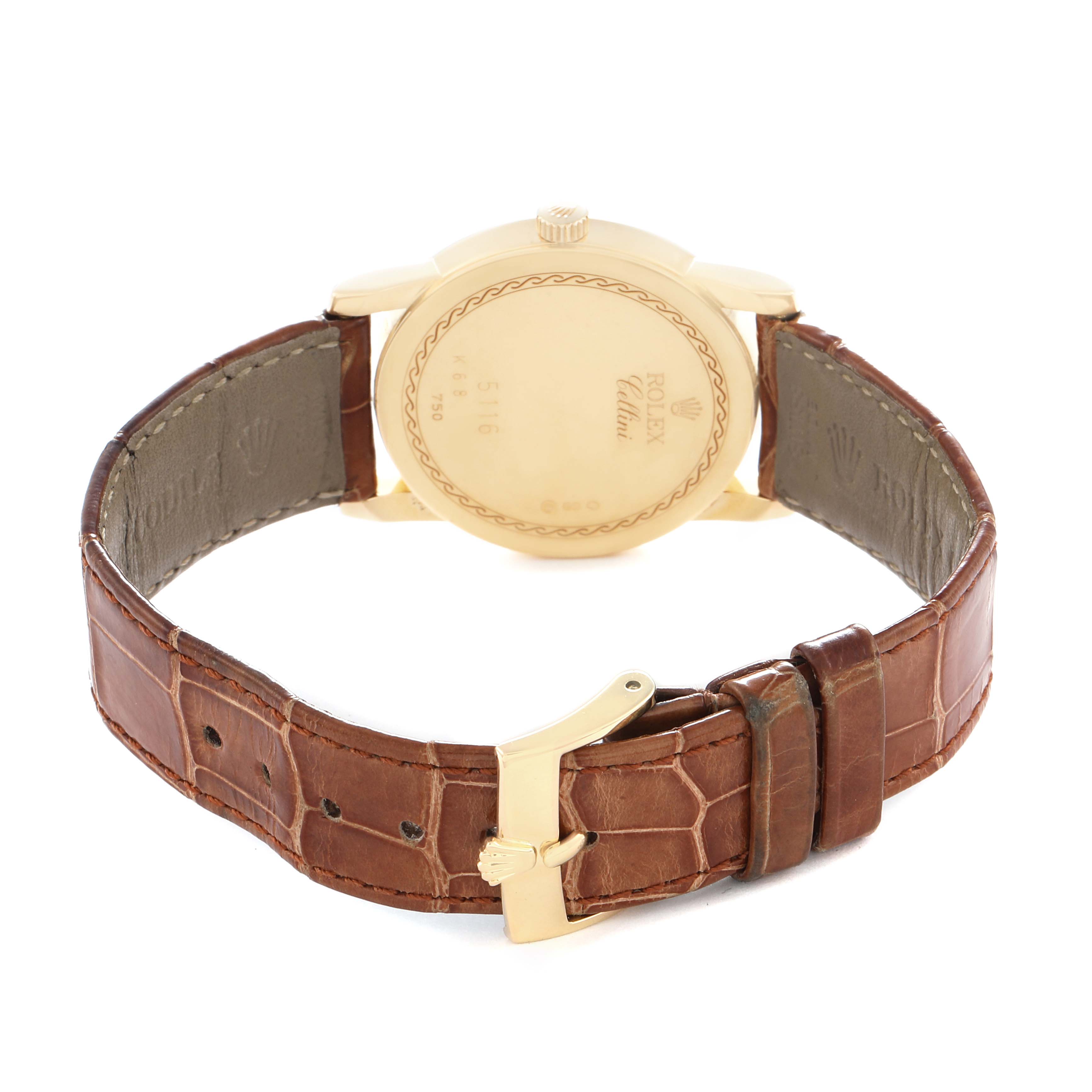 The Rolex Cellini 5116 Men
s Yellow Gold Beige Dial watch is shown from the back, displaying the case back, crown, and brown leather strap with a buckle.