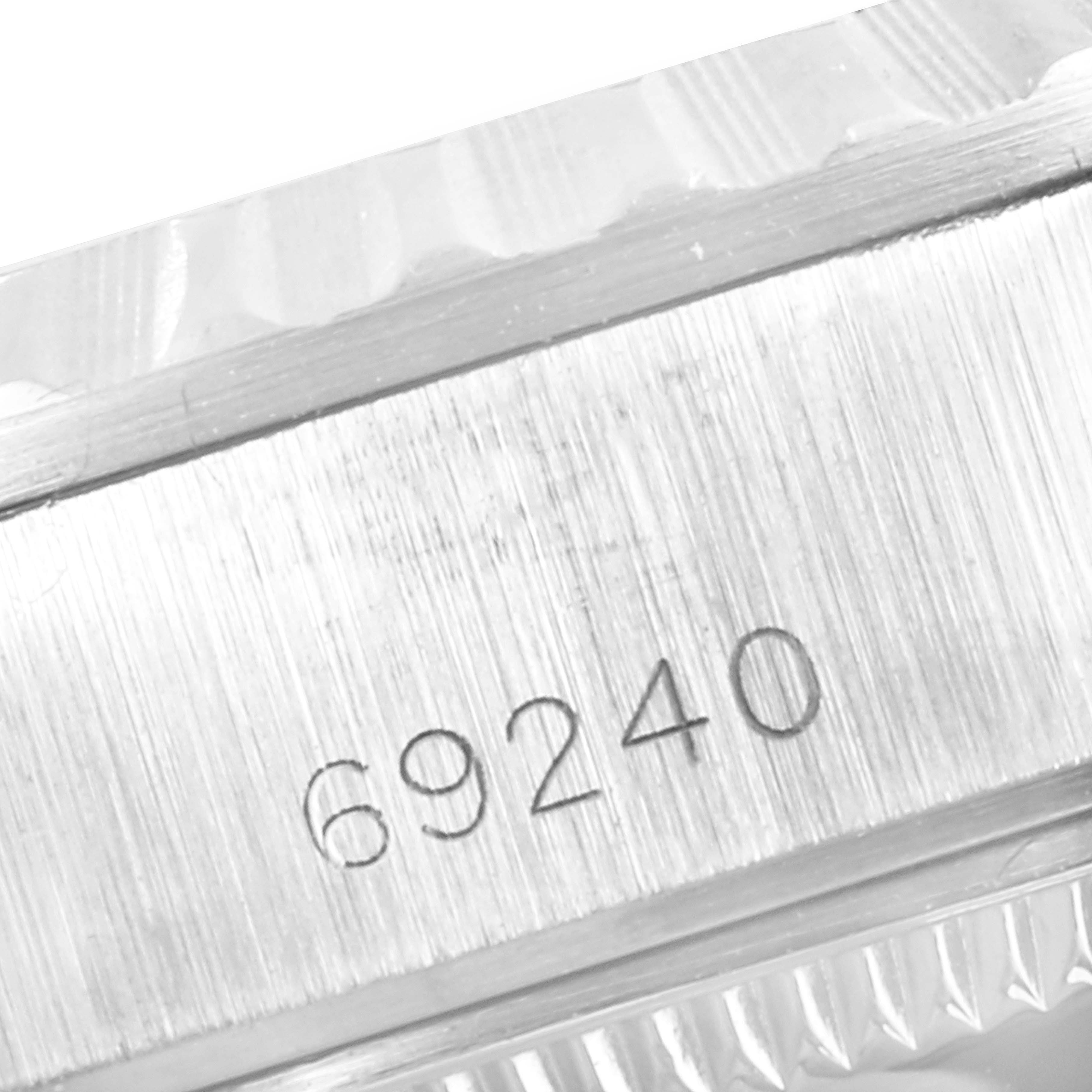 This is a close-up image showing the case number 69240 of a Rolex Date 69240 Women's Stainless Steel Grey Dial 69240 Women's Stainless Steel Grey Dial model watch.