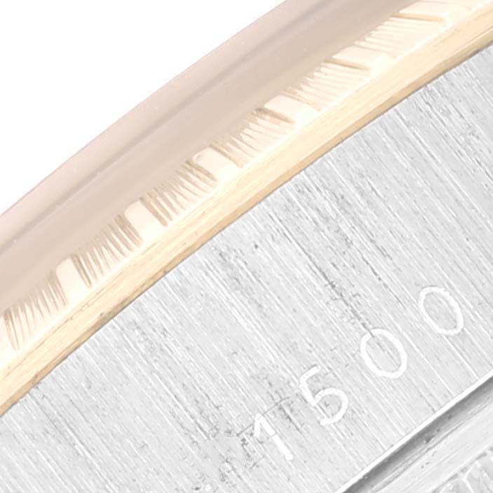 This close-up image shows a portion of the bezel and dial edges of the Rolex Vintage Collection 1500 Men's Steel and Gold (two tone) Black Dial 1500 Men's Steel and Gold (two tone) Black Dial watch.