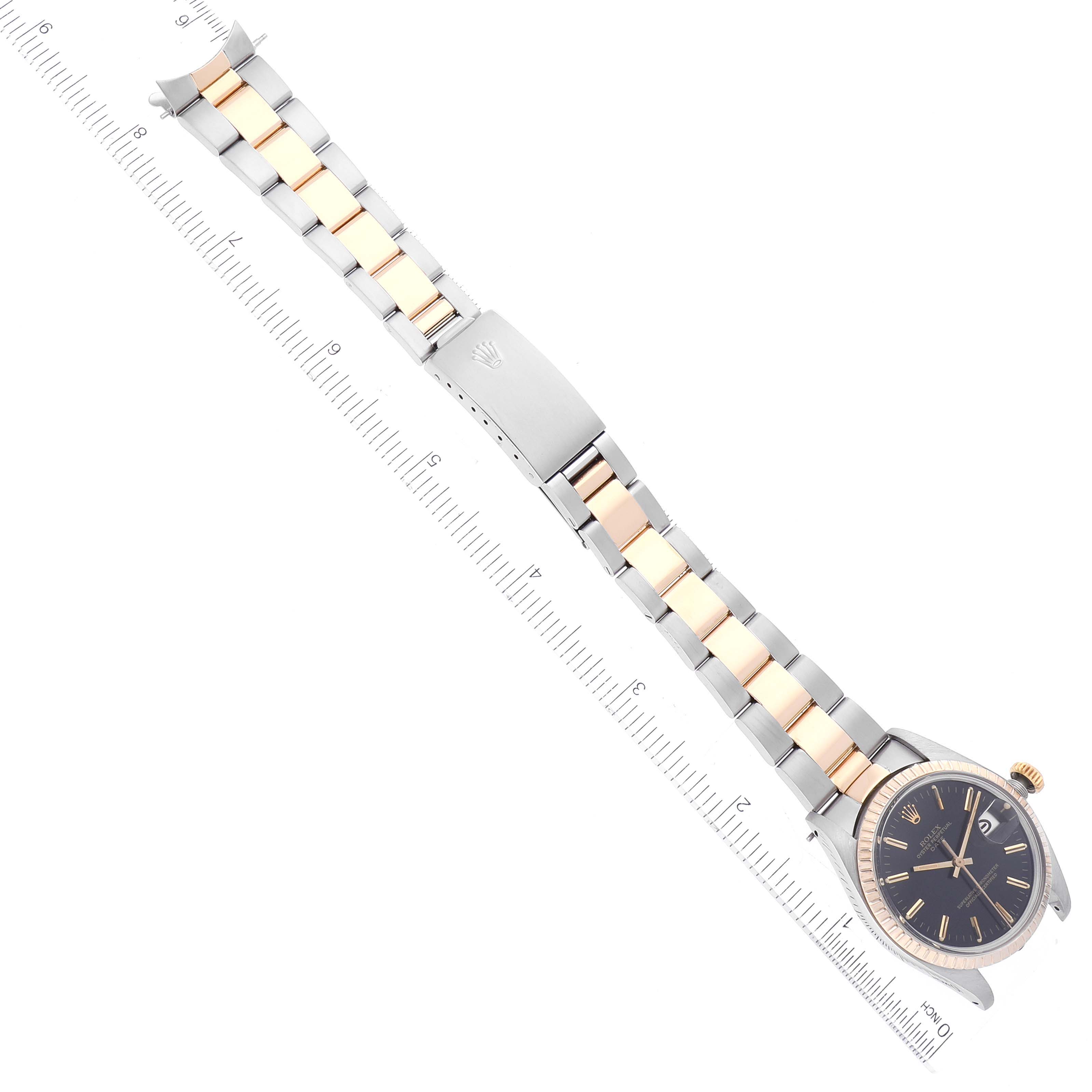 The Vintage Collection Rolex watch is displayed flat, showing the dial, bezel, crown, and full length of the two-tone bracelet with the clasp open.