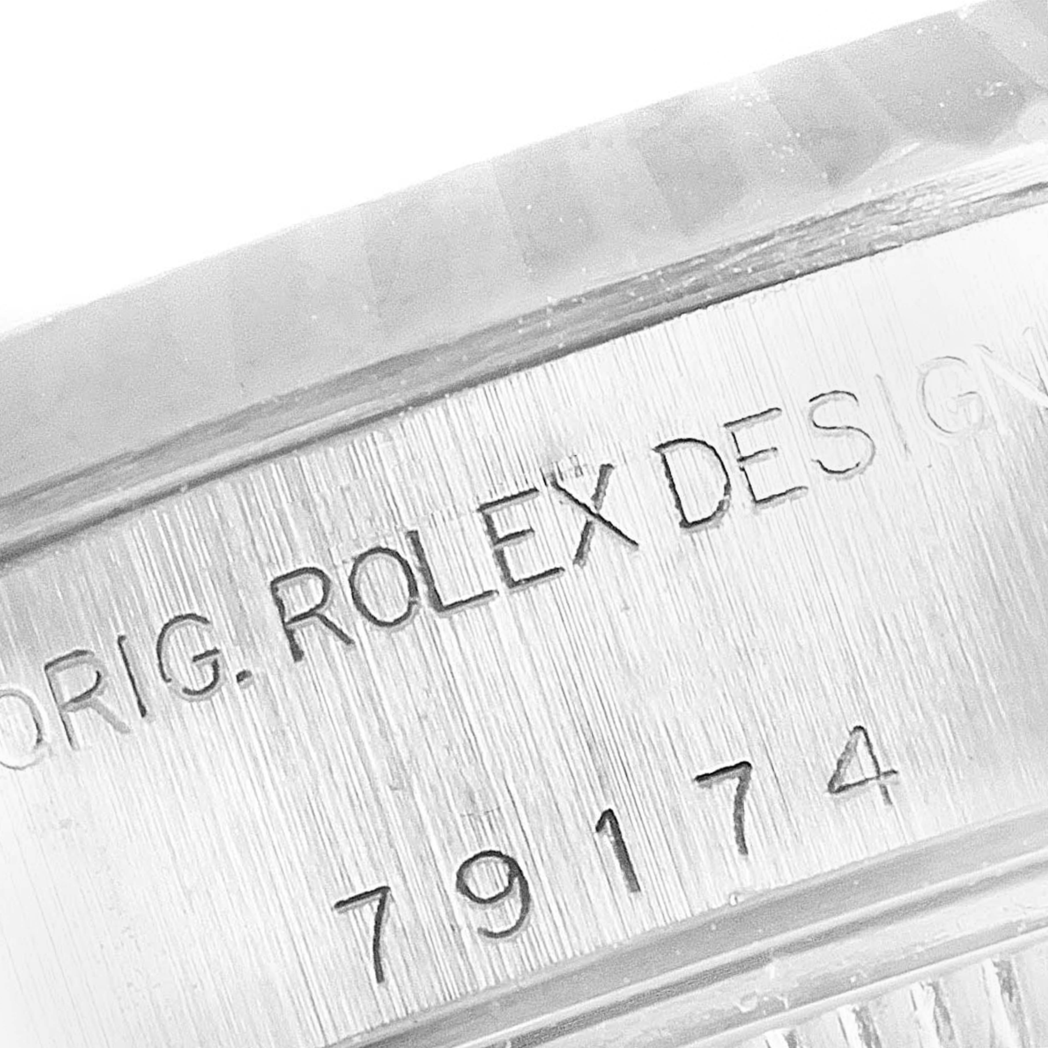 The image shows a close-up of the Rolex Datejust 79174 Women
s Stainless Steel Silver Dial 79174 Women
s Stainless Steel Silver Dial model
s serial and design numbers engraved on the side of the watch case.