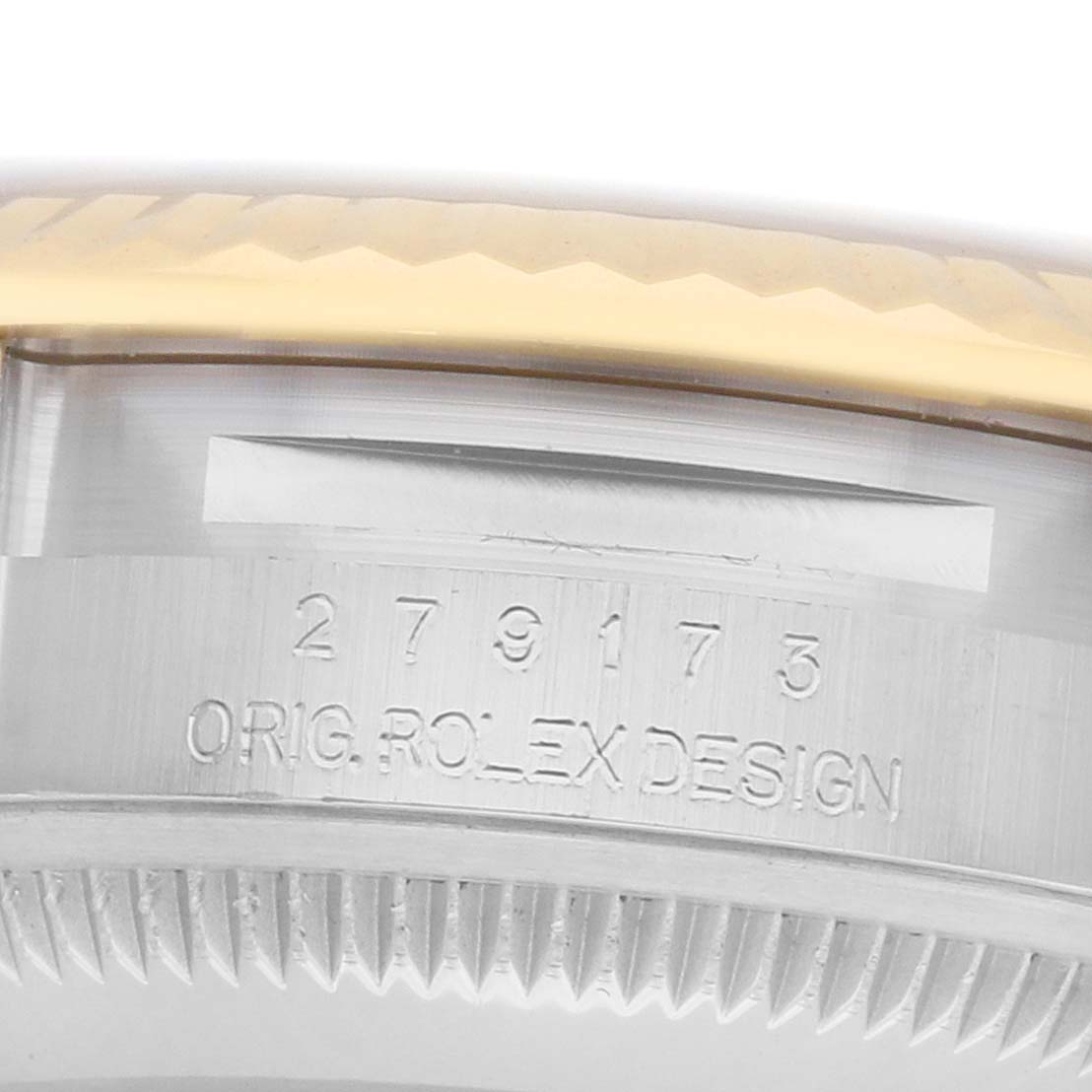 The image shows a close-up of the side of a Rolex Datejust 279173 Women
s Steel and Gold (two tone) Silver Dial, highlighting the engraved model number and part of the bezel.