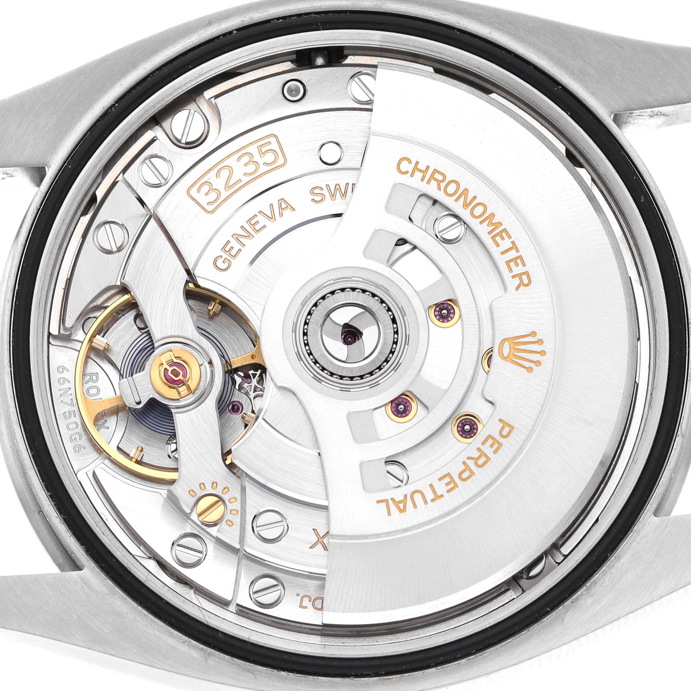 The image shows the movement of a Rolex Datejust 126200 Men's Stainless Steel Green Dial watch, highlighting the rotor, gears, and "3235" caliber markings from the back.