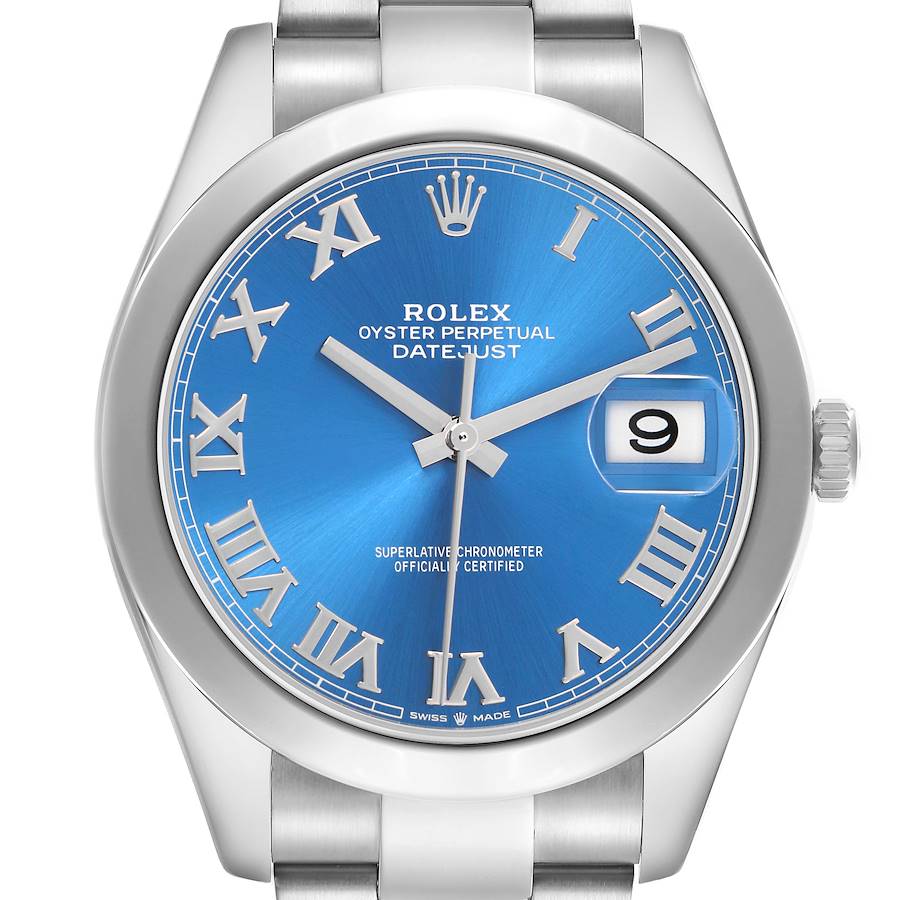 The image shows a frontal view of the Rolex Datejust model 126300 men
s watch, featuring a blue dial, Roman numerals, and a date display at 3 o
clock.