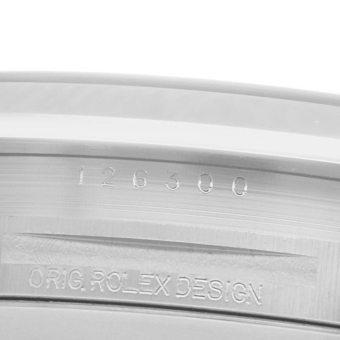 The image shows a close-up of the inner bezel with engraved details from a Rolex Datejust 126300 Men
s Stainless Steel Blue Dial.