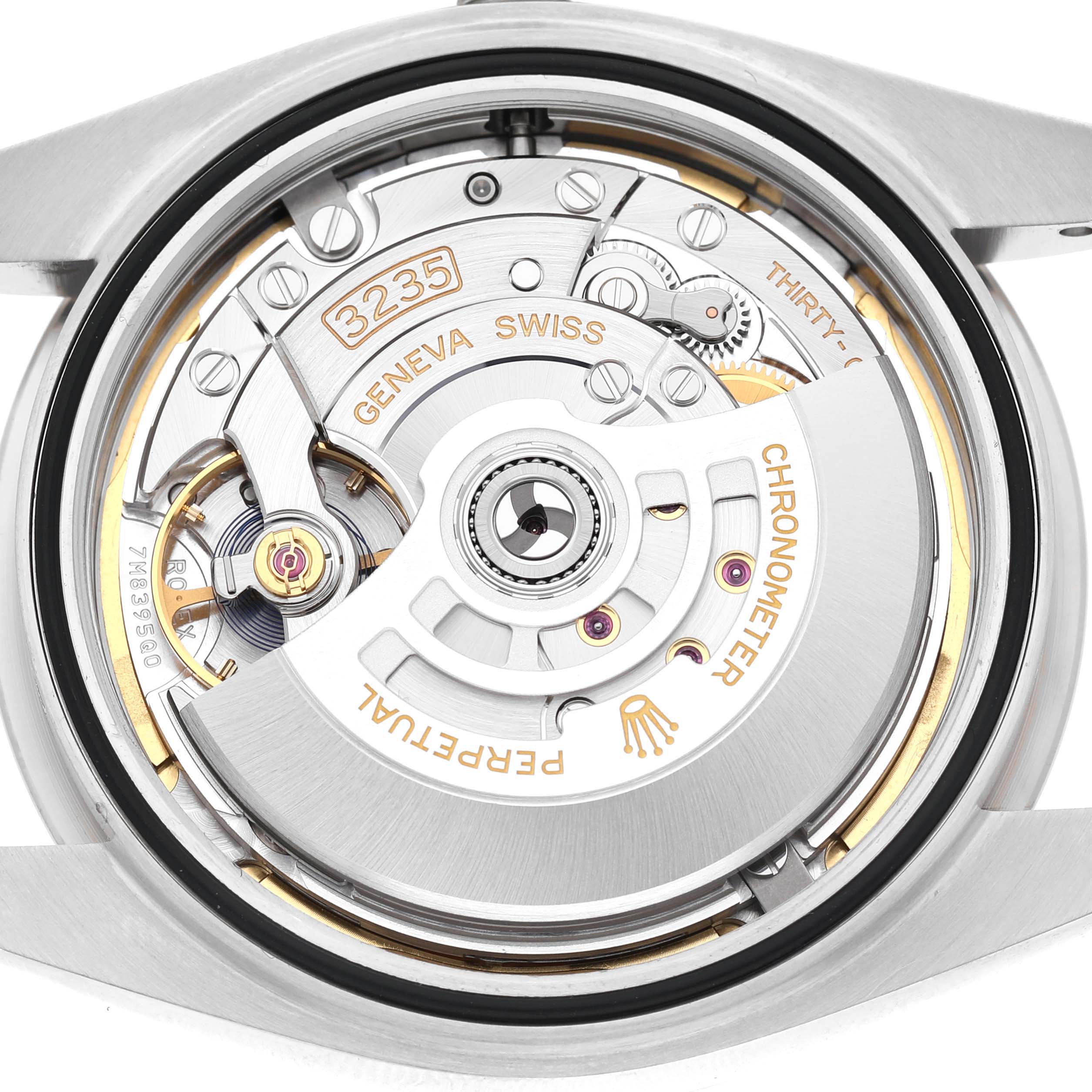 The image shows the movement of a Rolex Datejust 41 126334 Men's Stainless Steel Green Dial, displaying intricate components like the rotor and gears from a top view.