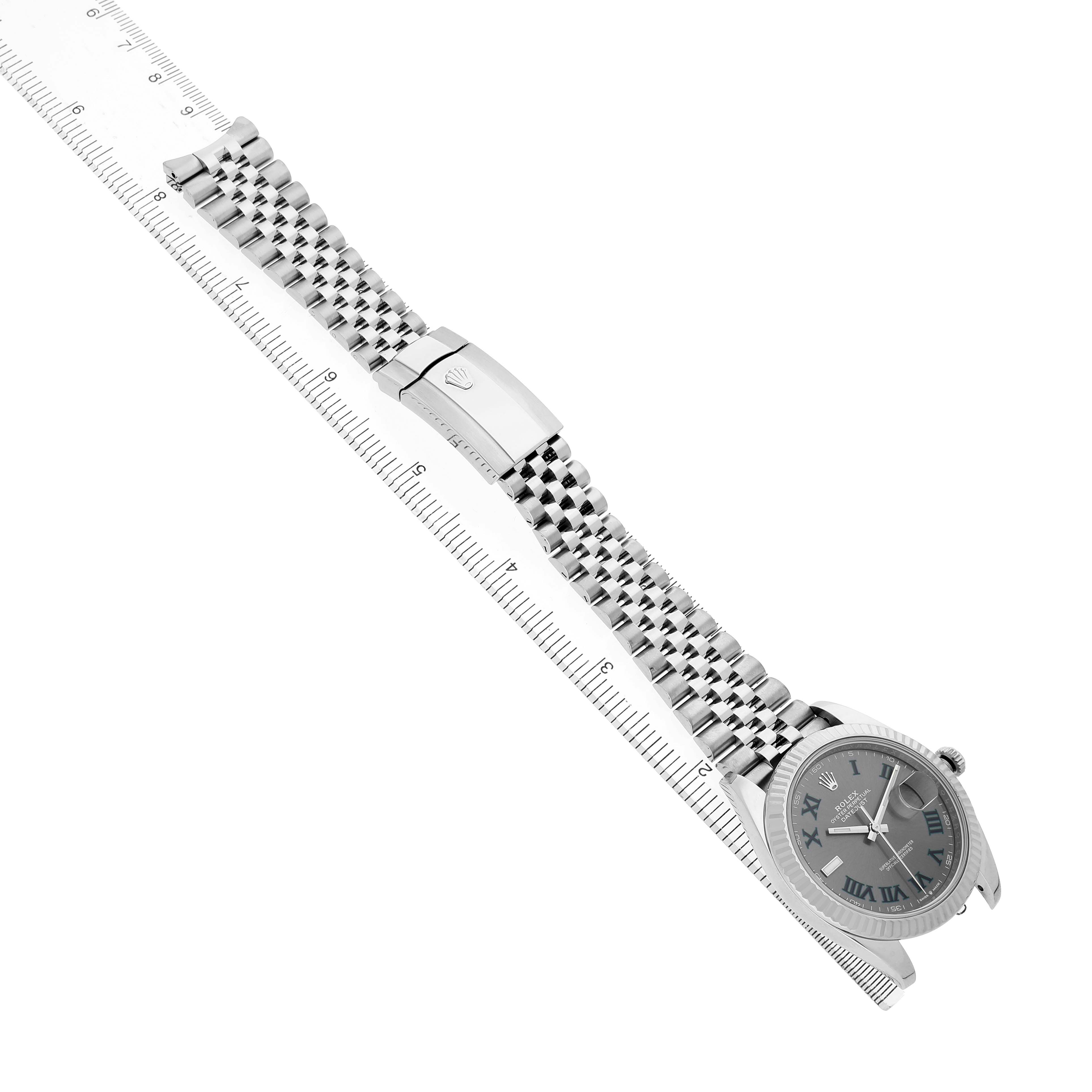 The Rolex Datejust 41 126334 Men's Stainless Steel Grey Dial is shown in profile with focus on its bracelet and clasp aligned with a measuring ruler.
