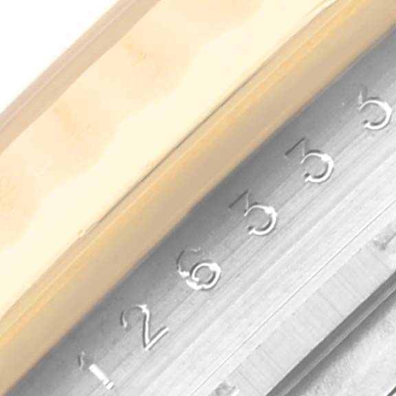 The image shows a close-up of the fluted bezel and partially visible rehaut with serial numbers of a Rolex Datejust 41 126333 Men's Steel and Gold (two tone) Champagne Dial 126333 Men's Steel and Gold (two tone) Champagne Dial.