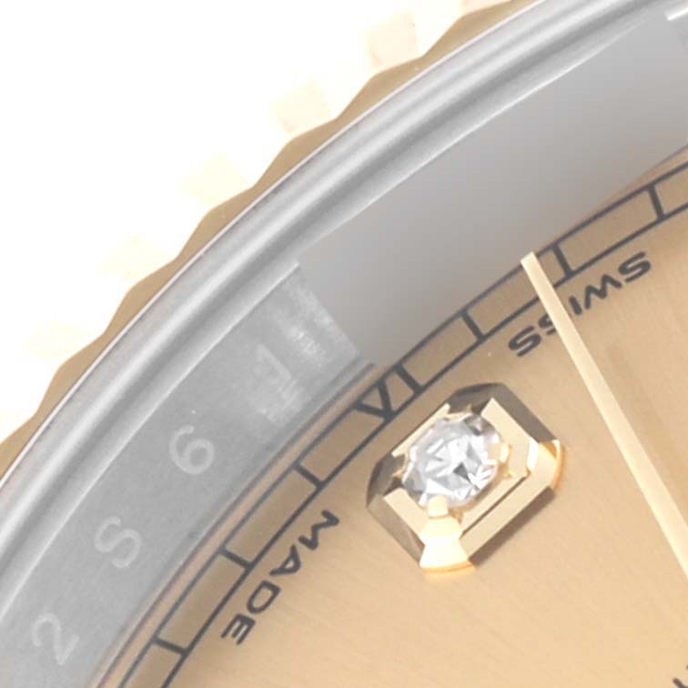 The image shows a close-up of the dial and bezel of a Rolex Datejust 41 126333 Men's Steel and Gold (two tone) Champagne Dial 126333 Men's Steel and Gold (two tone) Champagne Dial model, featuring a Roman numeral and a diamond hour marker.