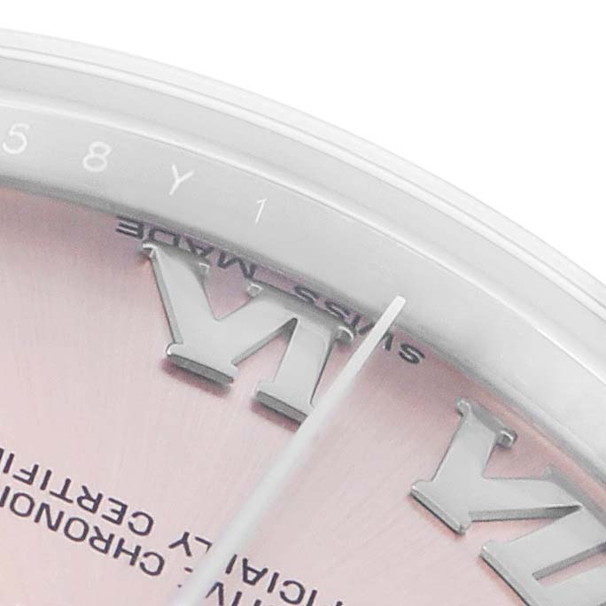 The image shows a close-up of the dial on a Rolex Datejust 178240 Women
s Stainless Steel Pink Dial, highlighting the hour markers and part of the minute hand.