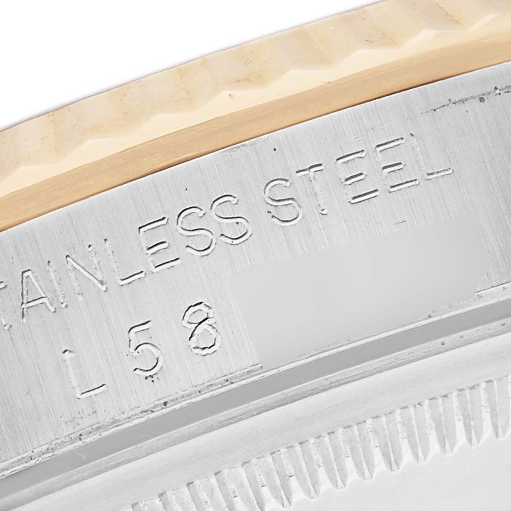 The image shows a close-up angle of the engraved "STAINLESS STEEL" marking on a Rolex Datejust 16233 Men's Steel and Gold (two tone) Black Dial 16233 Men's Steel and Gold (two tone) Black Dial watch's case.