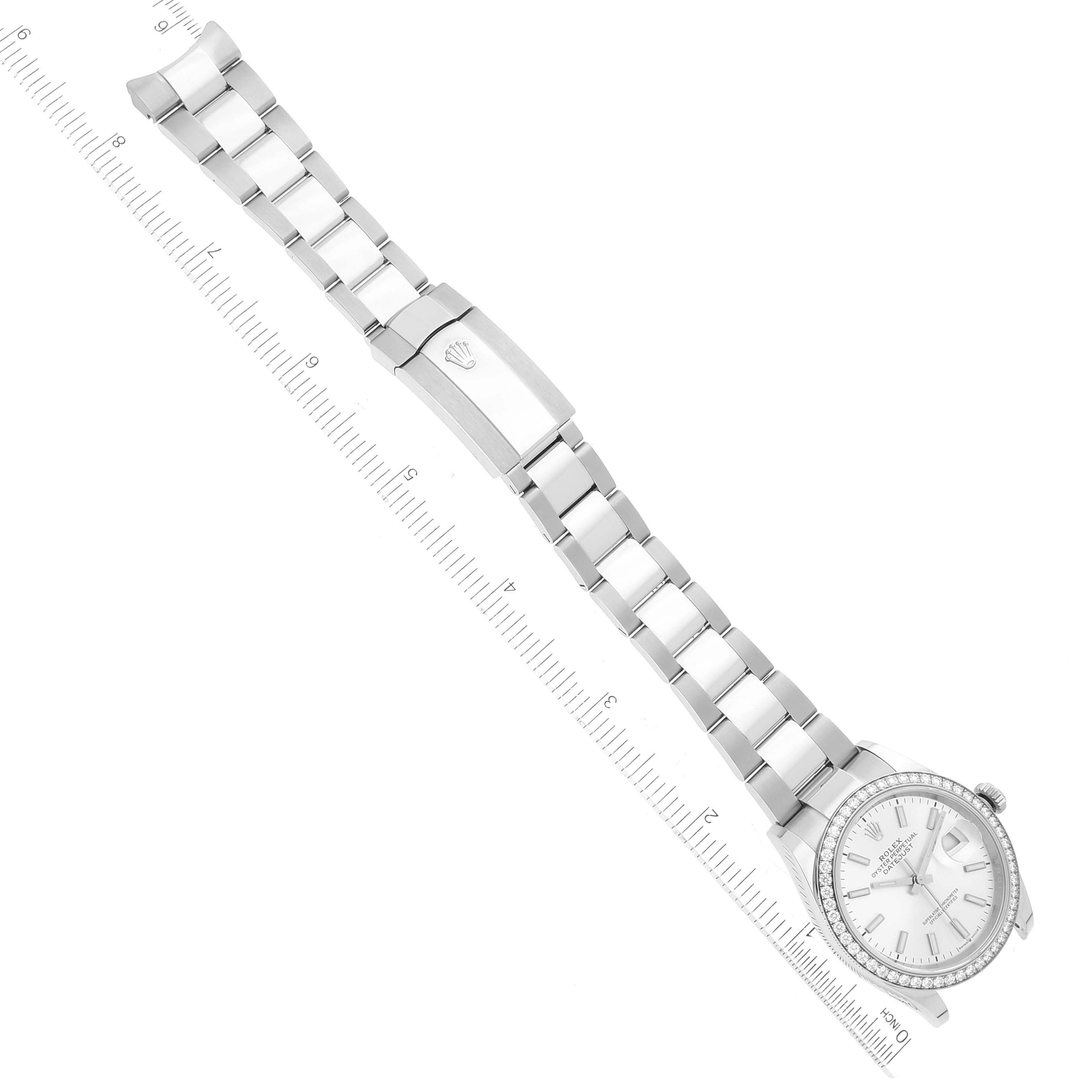 This image shows the full length of a Rolex Datejust 126284 Men's Stainless Steel Silver Dial 126284 Men's Stainless Steel Silver Dial watch, including the face, bezel, bracelet, and clasp, laid flat next to a ruler.