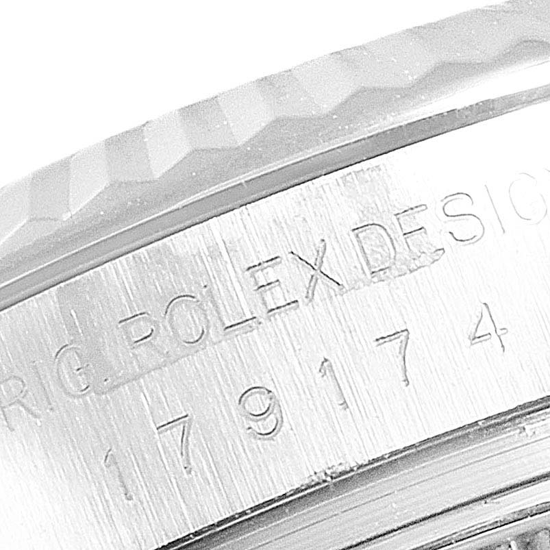 The image shows a close-up of the side of a Rolex Datejust 179174 Women's Stainless Steel Silver Dial 179174 Women's Stainless Steel Silver Dial watch case, highlighting the bezel and engraved text.