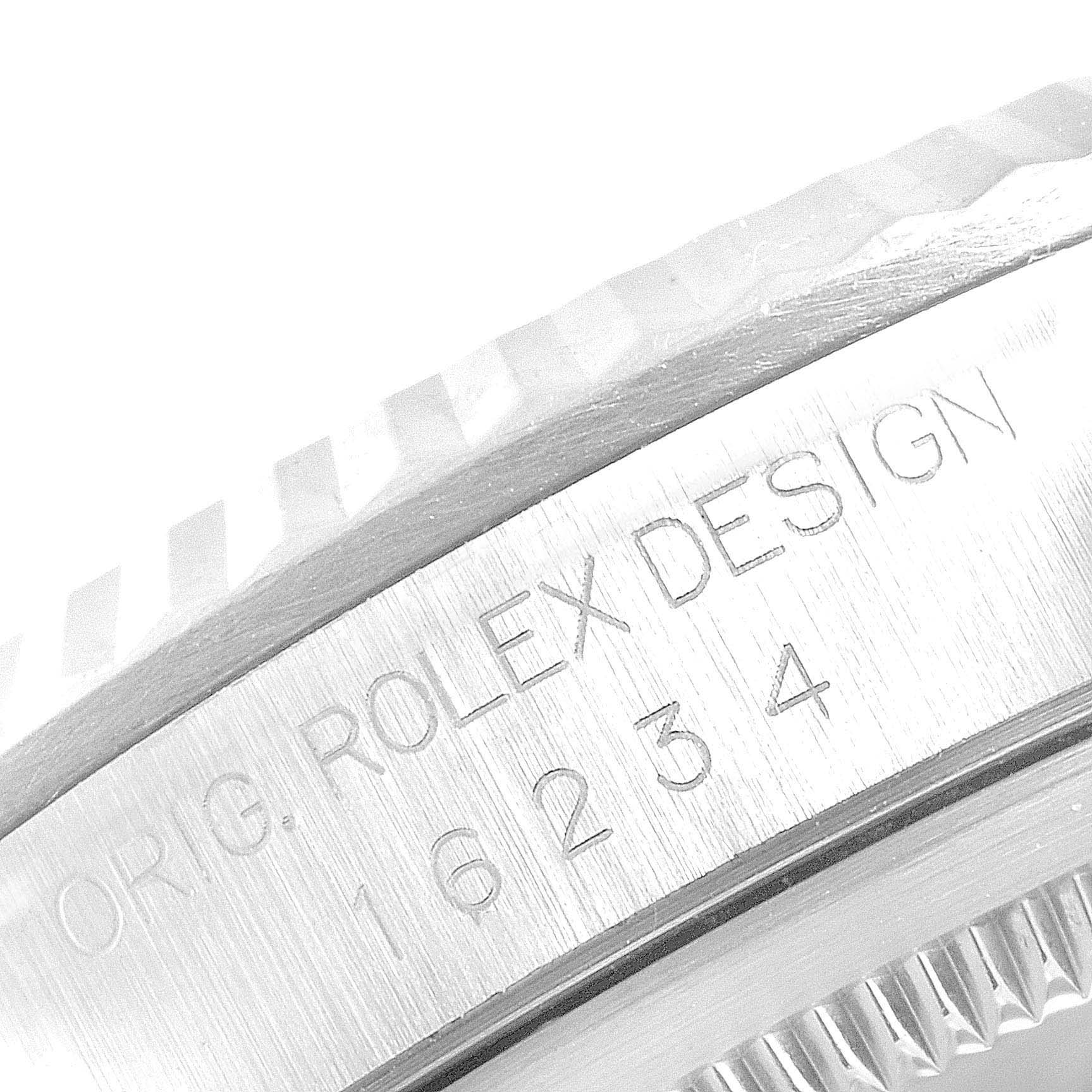 This image shows a close-up of the engraved case side of a Rolex Datejust 16234 Men's Stainless Steel Silver Dial 16234 Men's Stainless Steel Silver Dial model, highlighting the serial number and "ORIG ROLEX DESIGN."