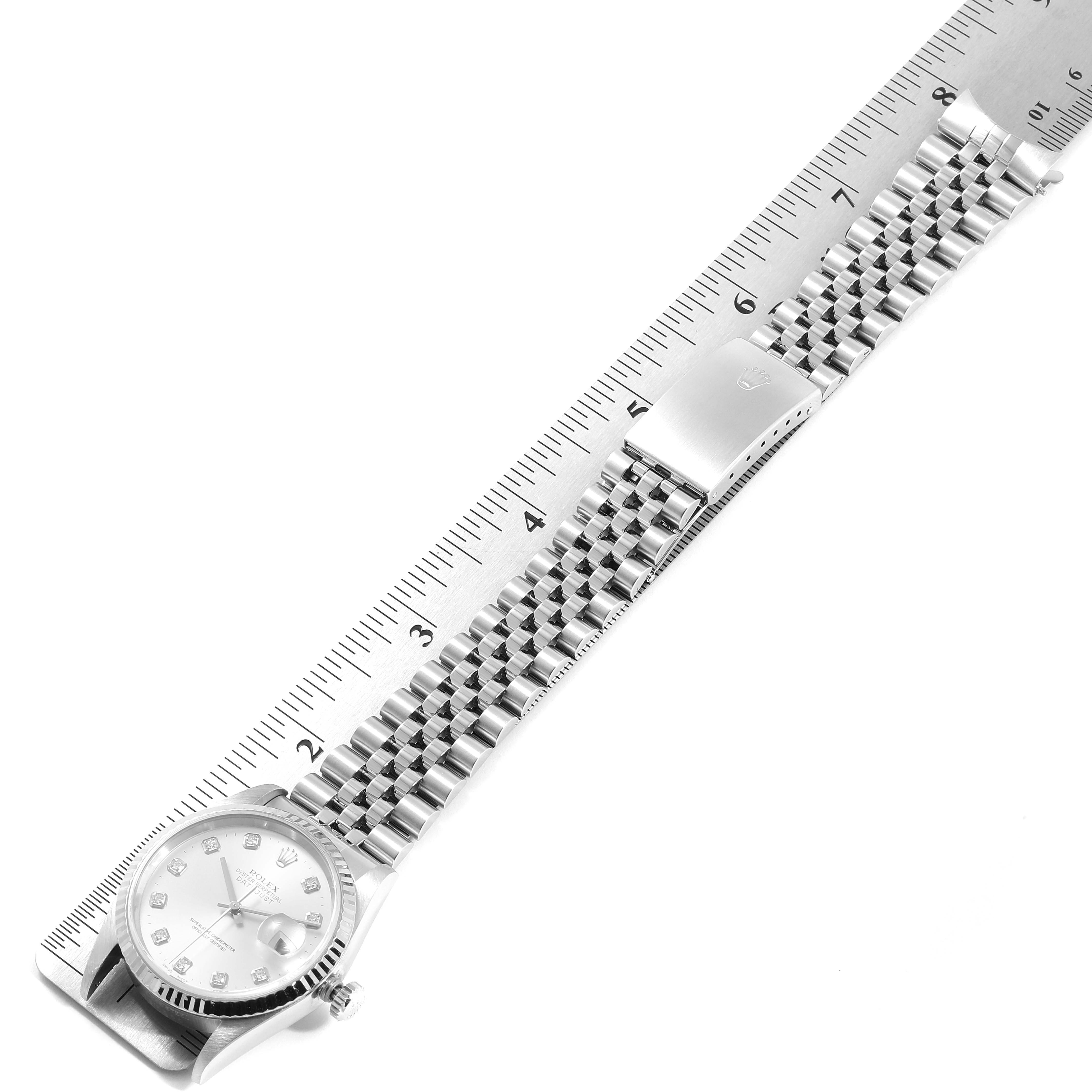 The Rolex Datejust 16234 Men's Stainless Steel Silver Dial 16234 Men's Stainless Steel Silver Dial watch is displayed flat with its integrated bracelet extended, accompanied by a measuring ruler for scale.
