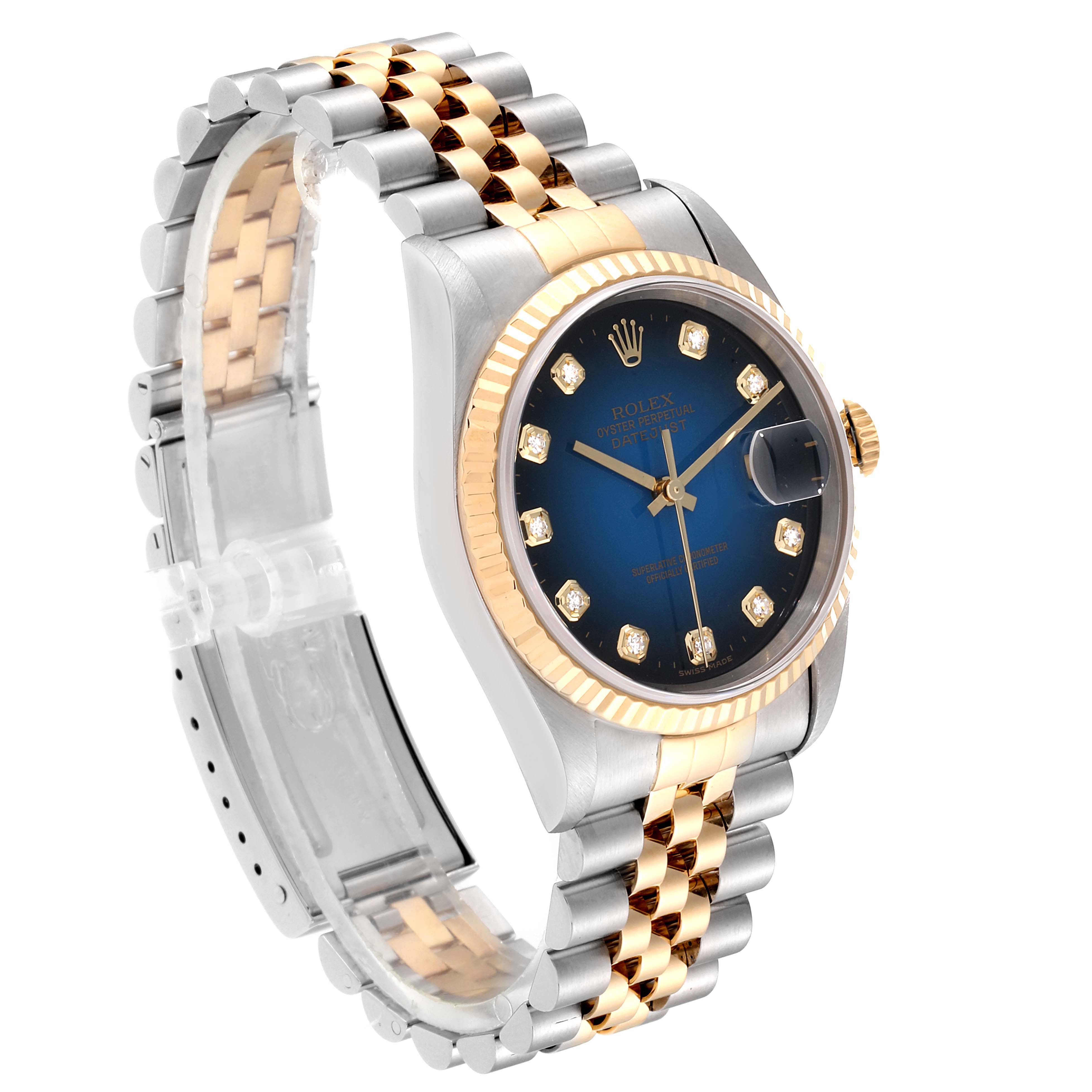 The Rolex Datejust 16233 Men's Steel and Gold (two tone) Blue Dial 16233 Men's Steel and Gold (two tone) Blue Dial watch is shown from an angled view, highlighting the two-tone bracelet, blue dial, and fluted bezel.