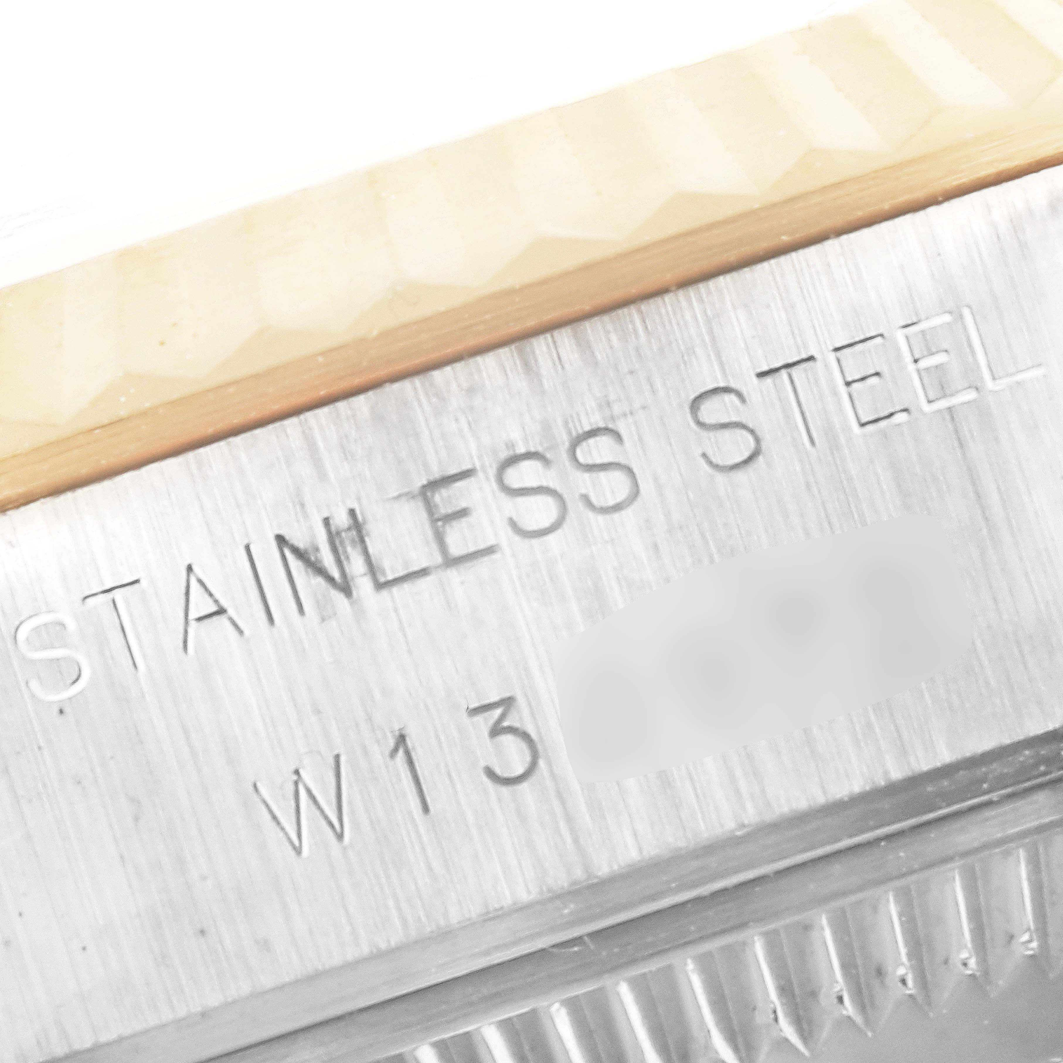 This close-up image shows the stainless steel text and part of the bezel on a Rolex Datejust 69173 Women's Steel and Gold (two tone) White Dial 69173 Women's Steel and Gold (two tone) White Dial watch.