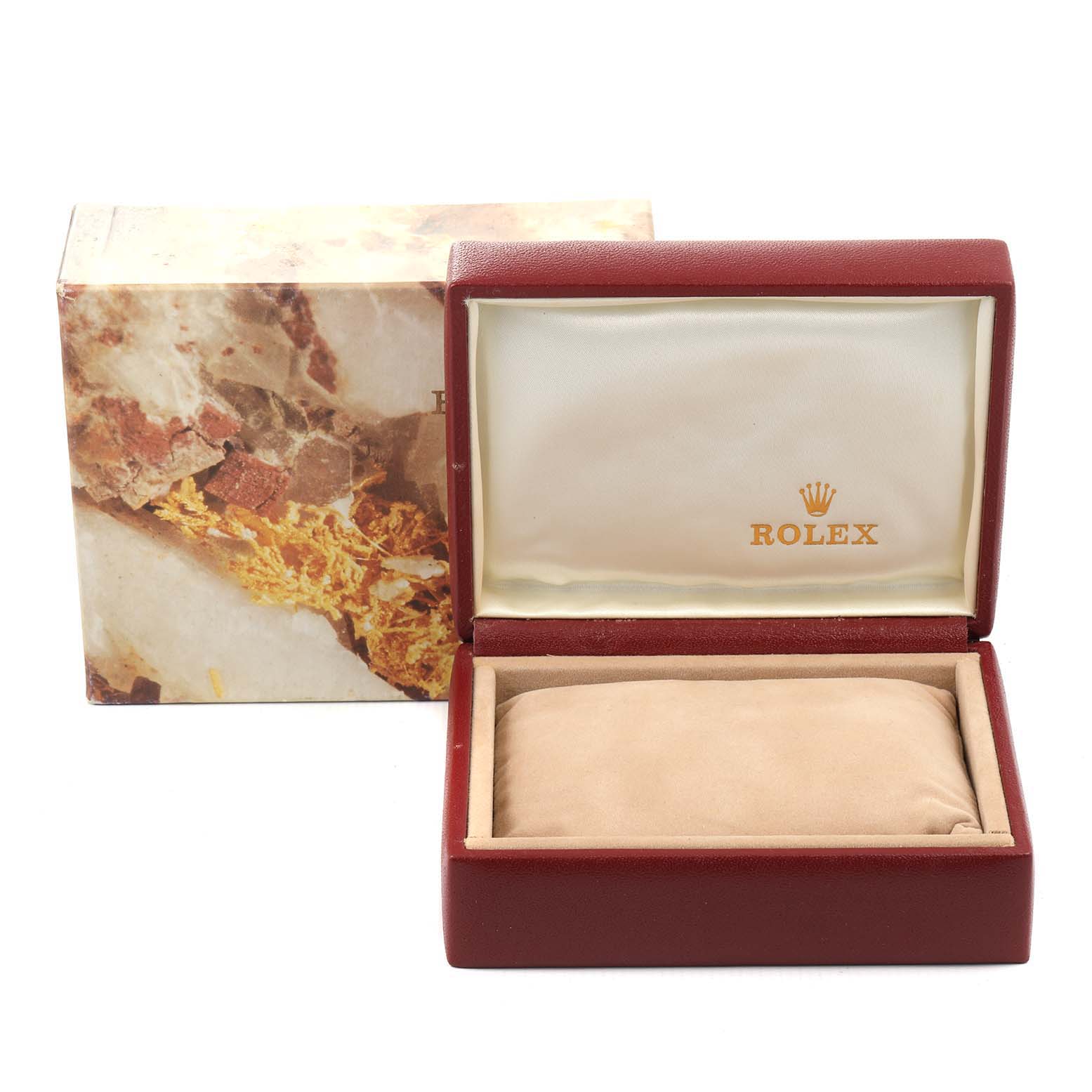 This image shows an open Rolex Datejust 69173 Women's Steel and Gold (two tone) White Dial 69173 Women's Steel and Gold (two tone) White Dial watch box with the cushion inside and the outer packaging in the background.