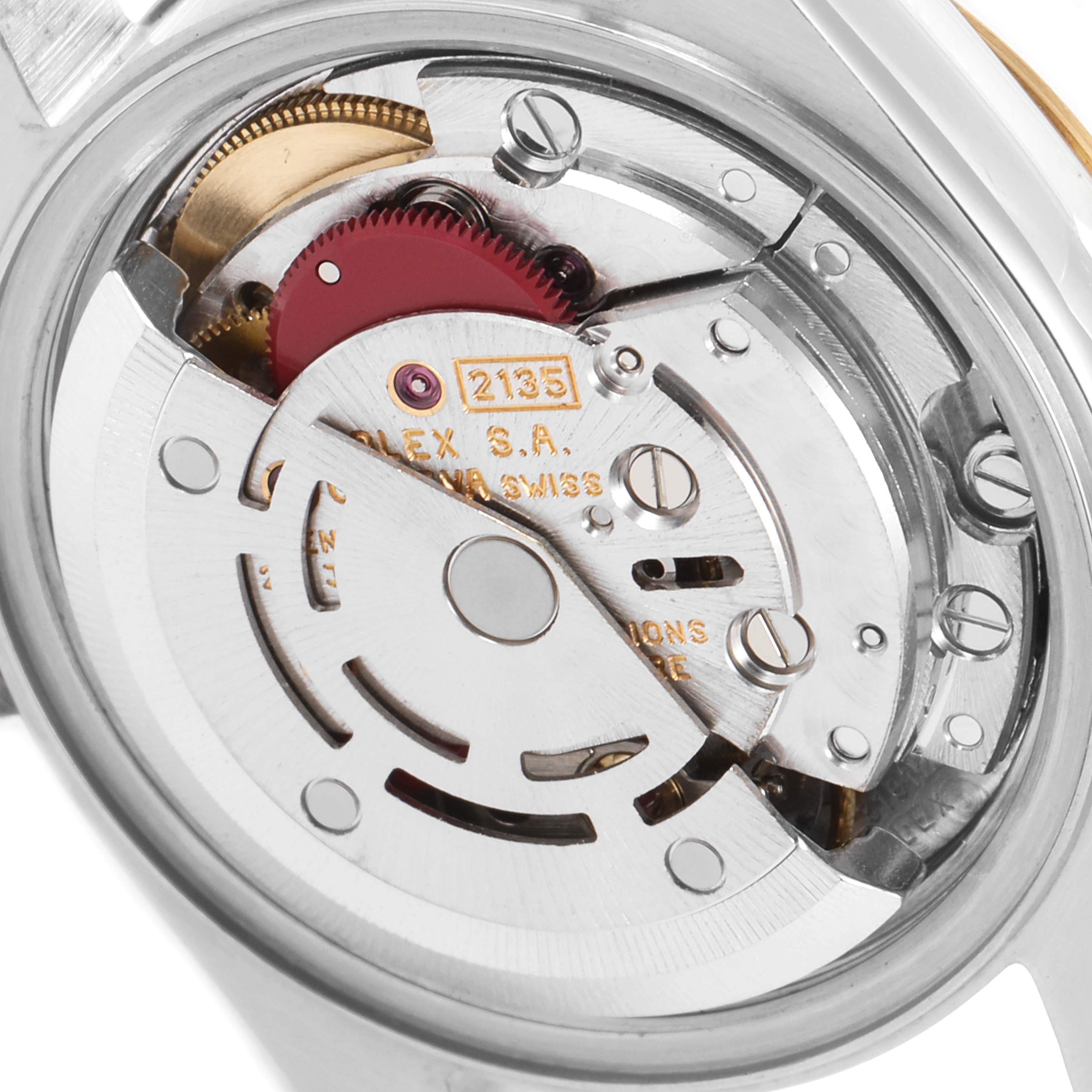 The image shows the internal mechanism of a Rolex Datejust 69173 Women's Steel and Gold (two tone) White Dial 69173 Women's Steel and Gold (two tone) White Dial watch, featuring gears and the rotor assembly.