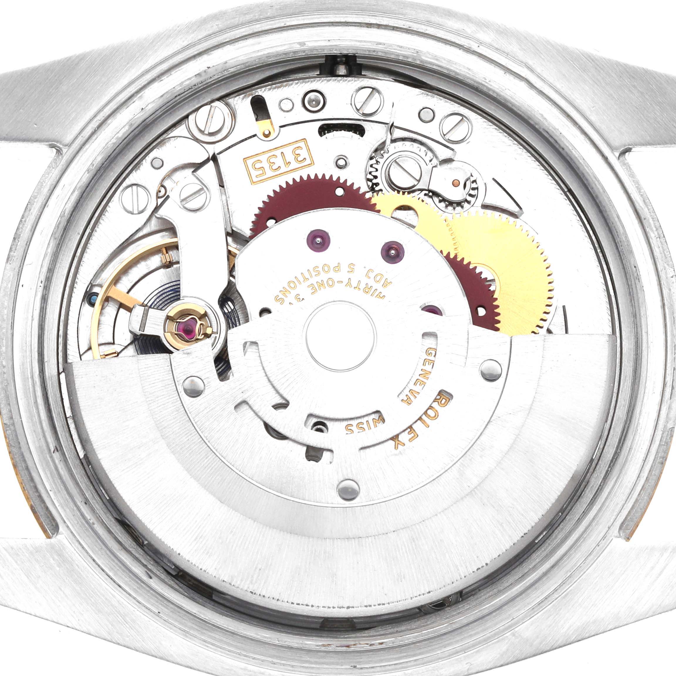 The image shows the movement of a Rolex Datejust 116233 Men
s Steel and Gold (two tone) Silver Dial from a top-down angle, highlighting gears and mechanical components.