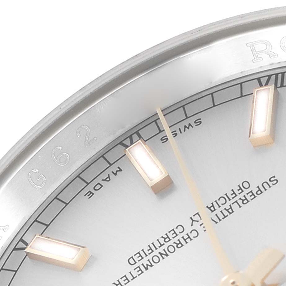 The image shows a close-up of the Rolex Datejust 116233 Men
s Steel and Gold (two tone) Silver Dial bezel, part of the dial, and hour markers.